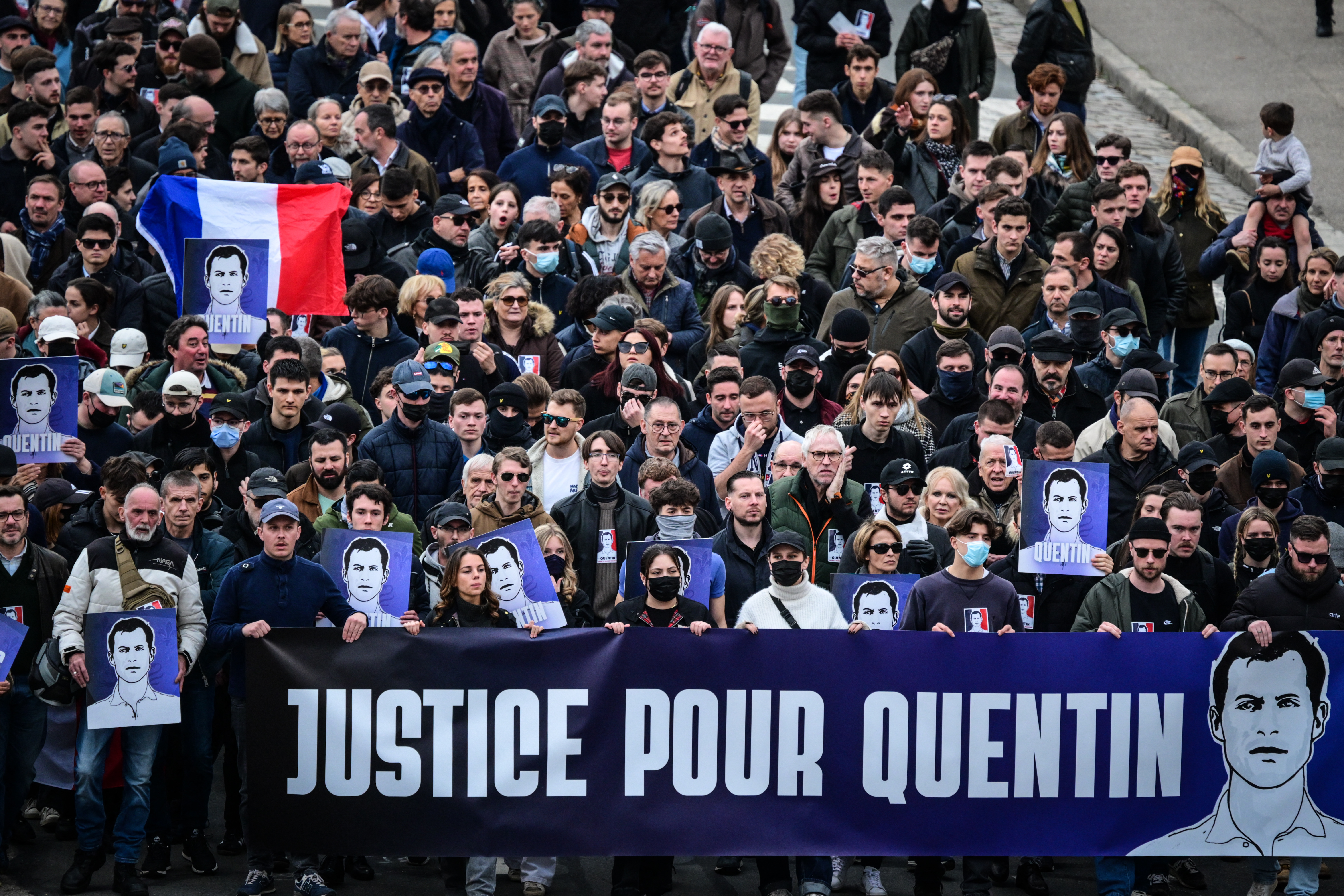 Protesters hold a banner reading "Justice for Quentin" during a march in tribute to far-right activist Quentin Deranque, who died after being attacked on the sidelines of a far-right protest against a La France Insoumise (LFI) event at Sciences Po Lyon, in Lyon on February 21, 2026.