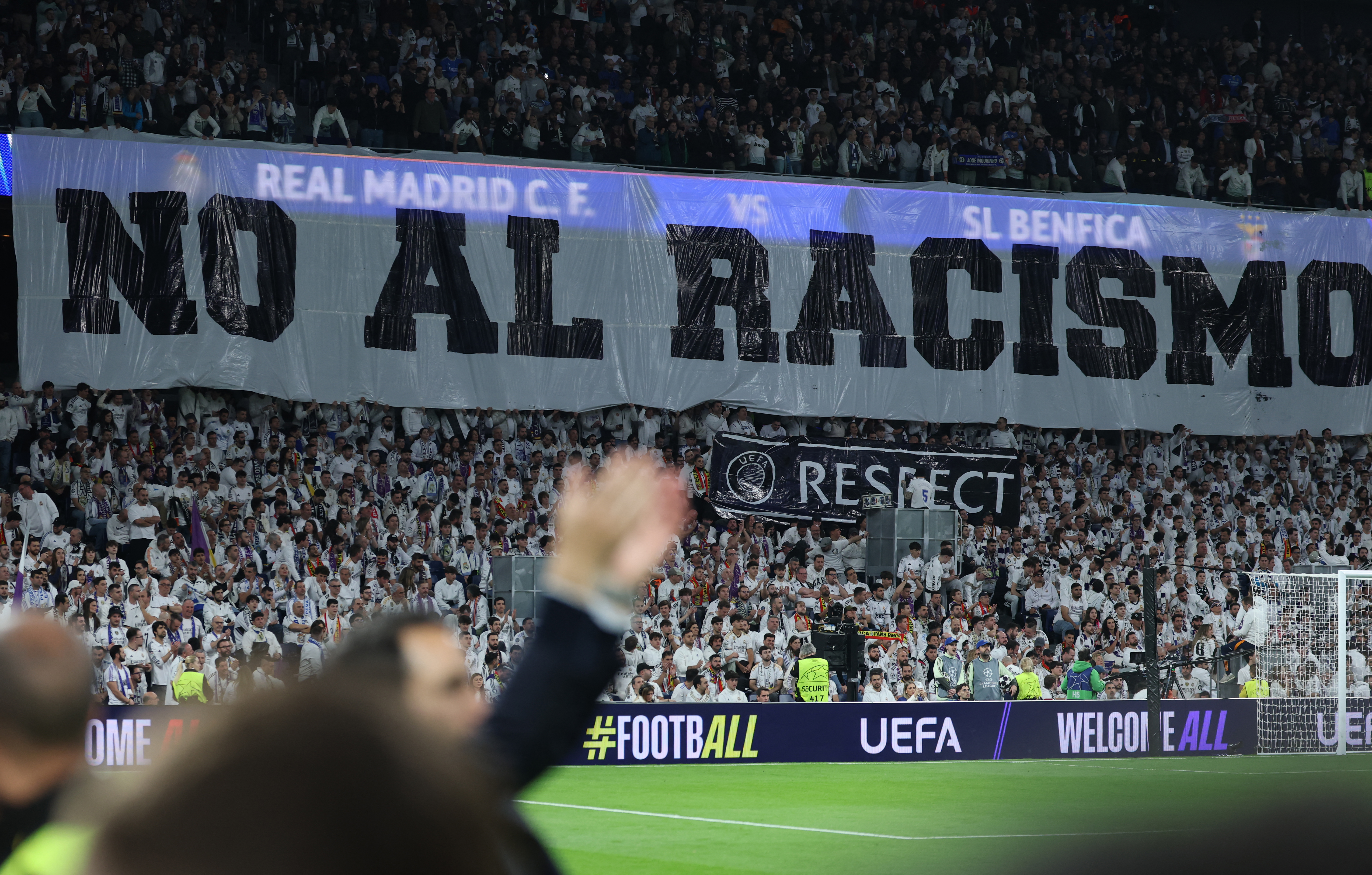 A banner against racism is displayed before the Champions League playoff second leg at the Santiago Bernabeu Stadium in Madrid