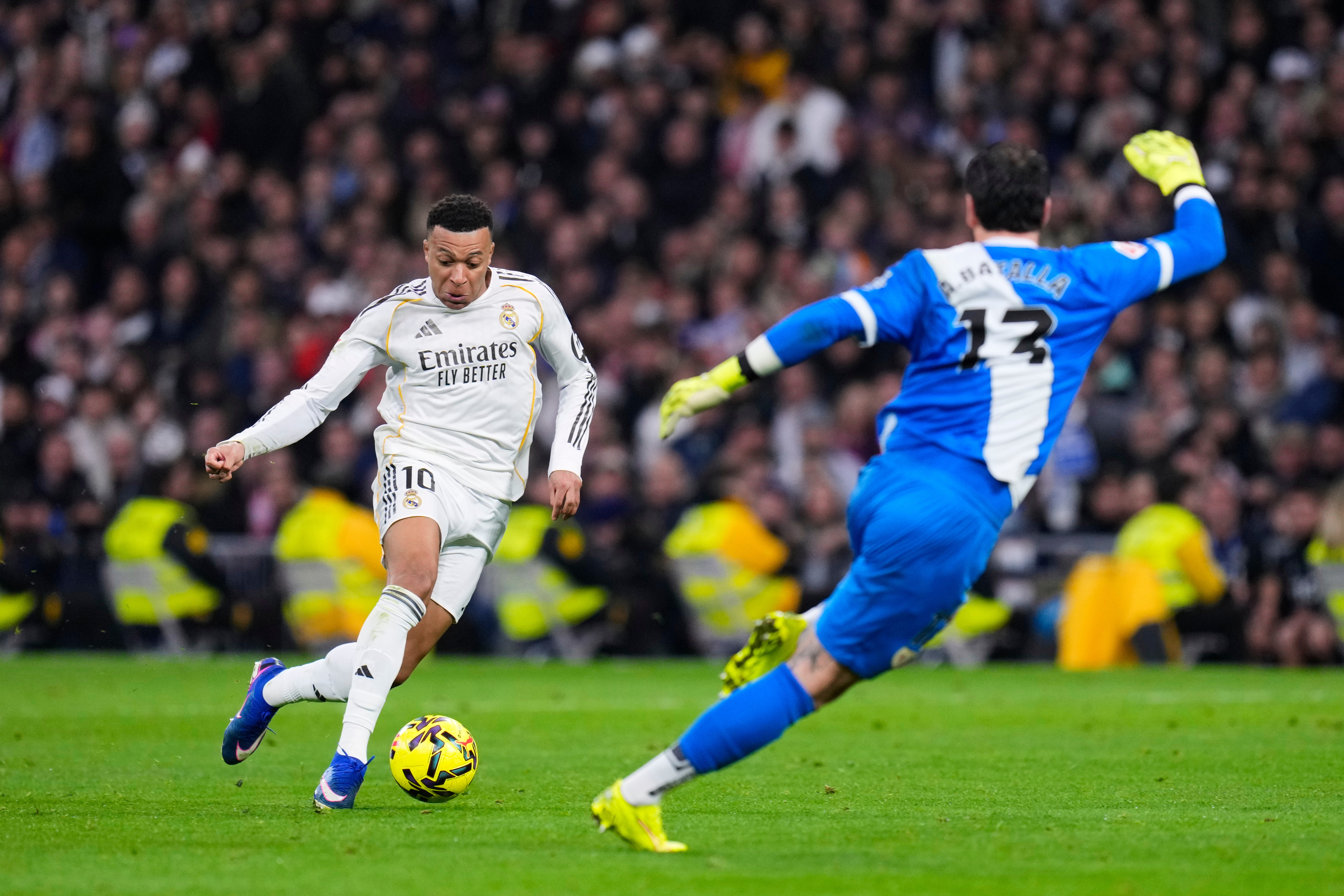 Real Madrid's Kylian Mbappe tries a shot next to Rayo's goalkeeper Augusto Batalla during the Spanish La Liga soccer match between Real Madrid and Rayo Vallecano in Madrid, Spain, Sunday, Feb. 1, 2026. (AP Photo/Manu Fernandez)