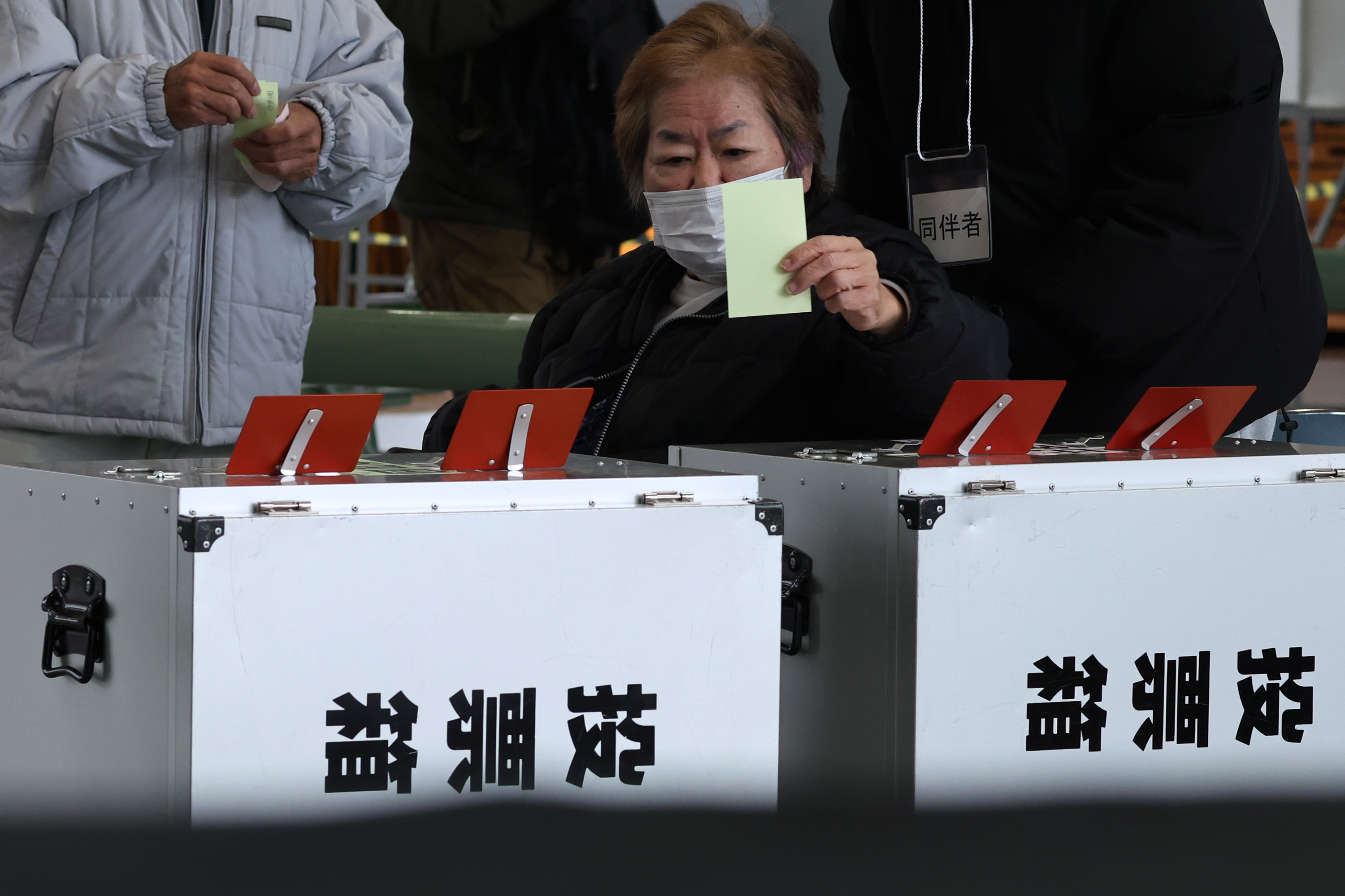 OSAKA, JAPAN - FEBRUARY 08: A voter casts her ballot at a polling station on February 08, 2026 in Osaka, Japan. Voters across the country headed to polls today as Japan's Lower House election was held. (Photo by Buddhika Weerasinghe/Getty Images)