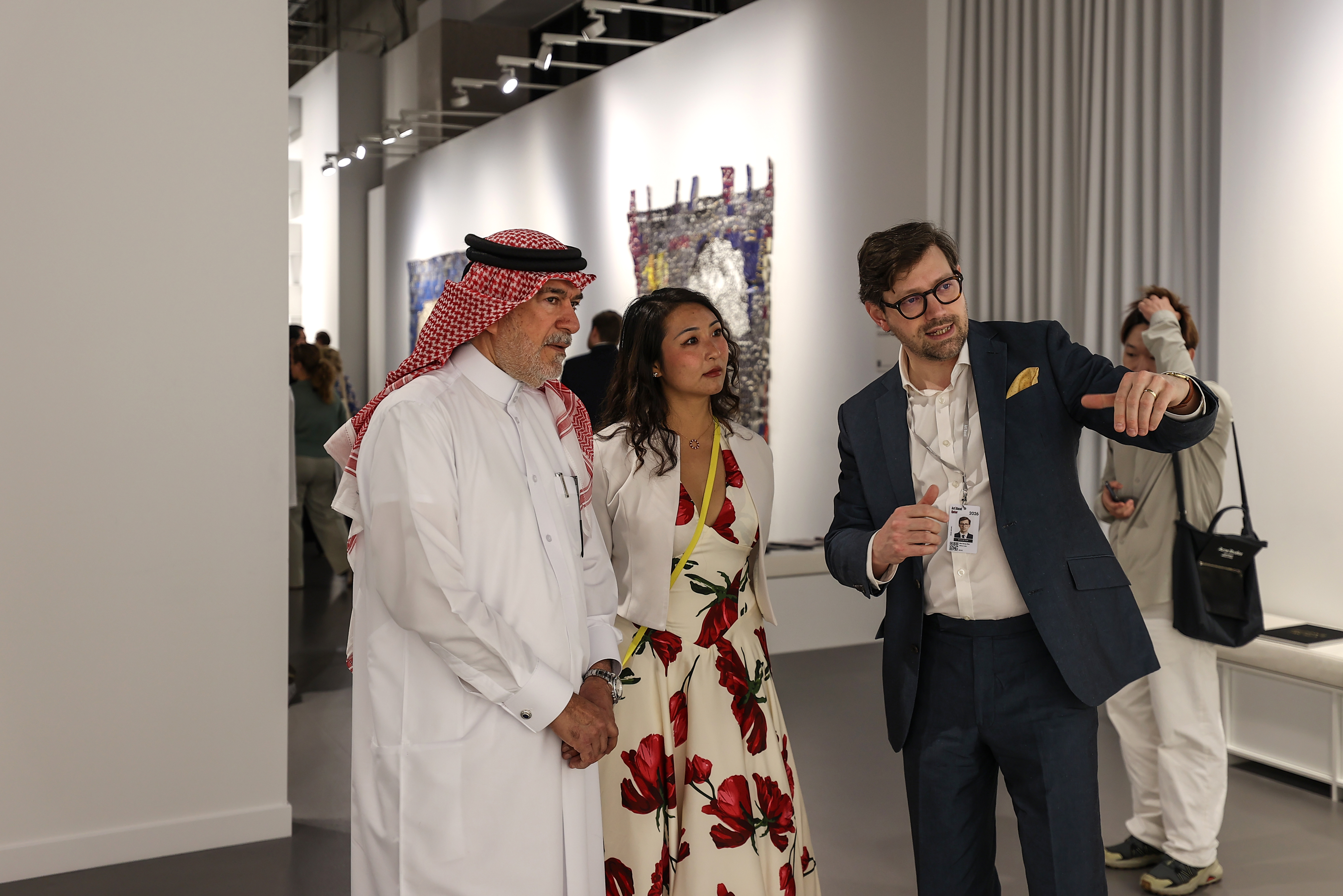 Visitors explore artworks and installations at the Art Basel Qatar Edition in Doha