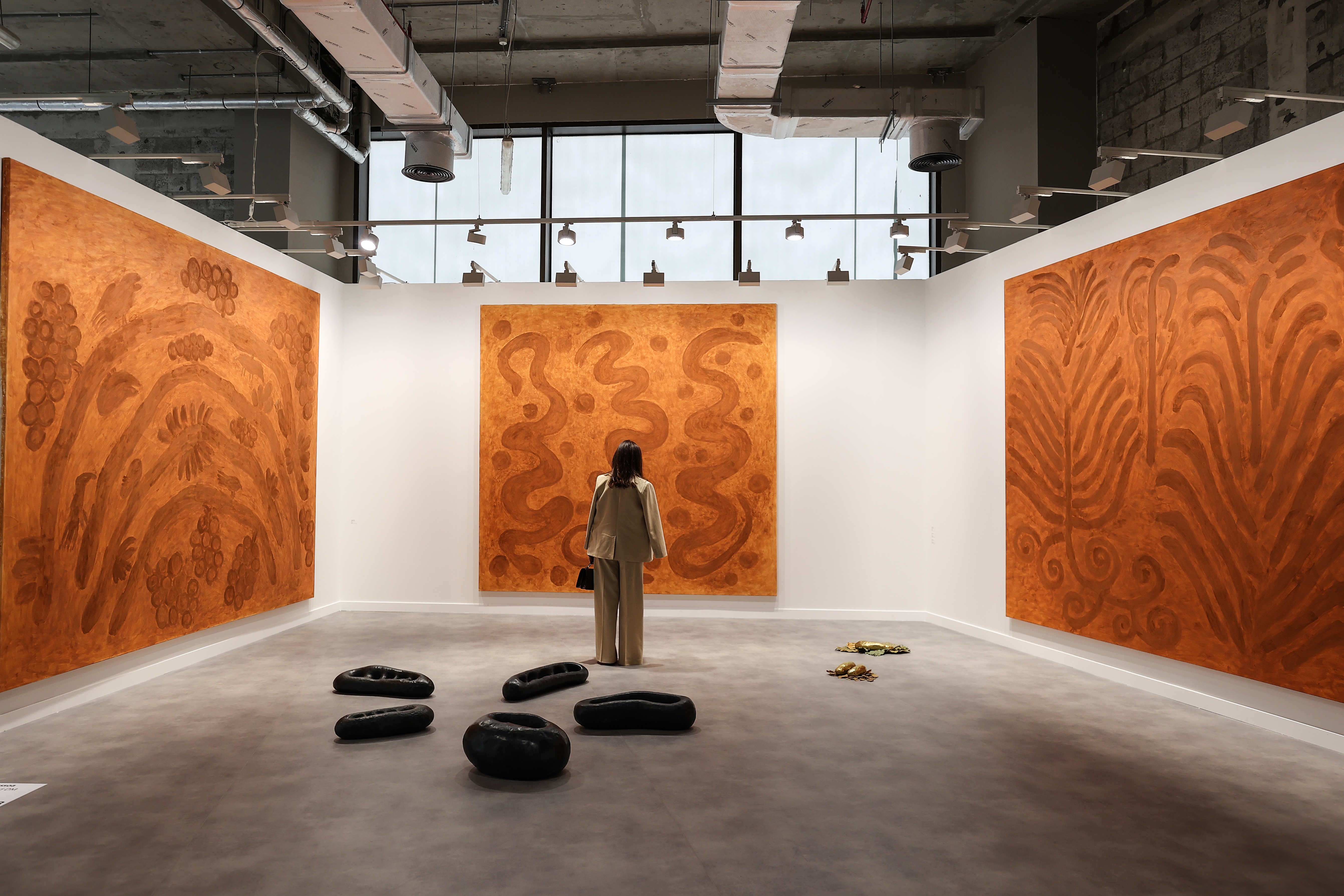 Visitors explore artworks and installations at the Art Basel Qatar Edition in Doha