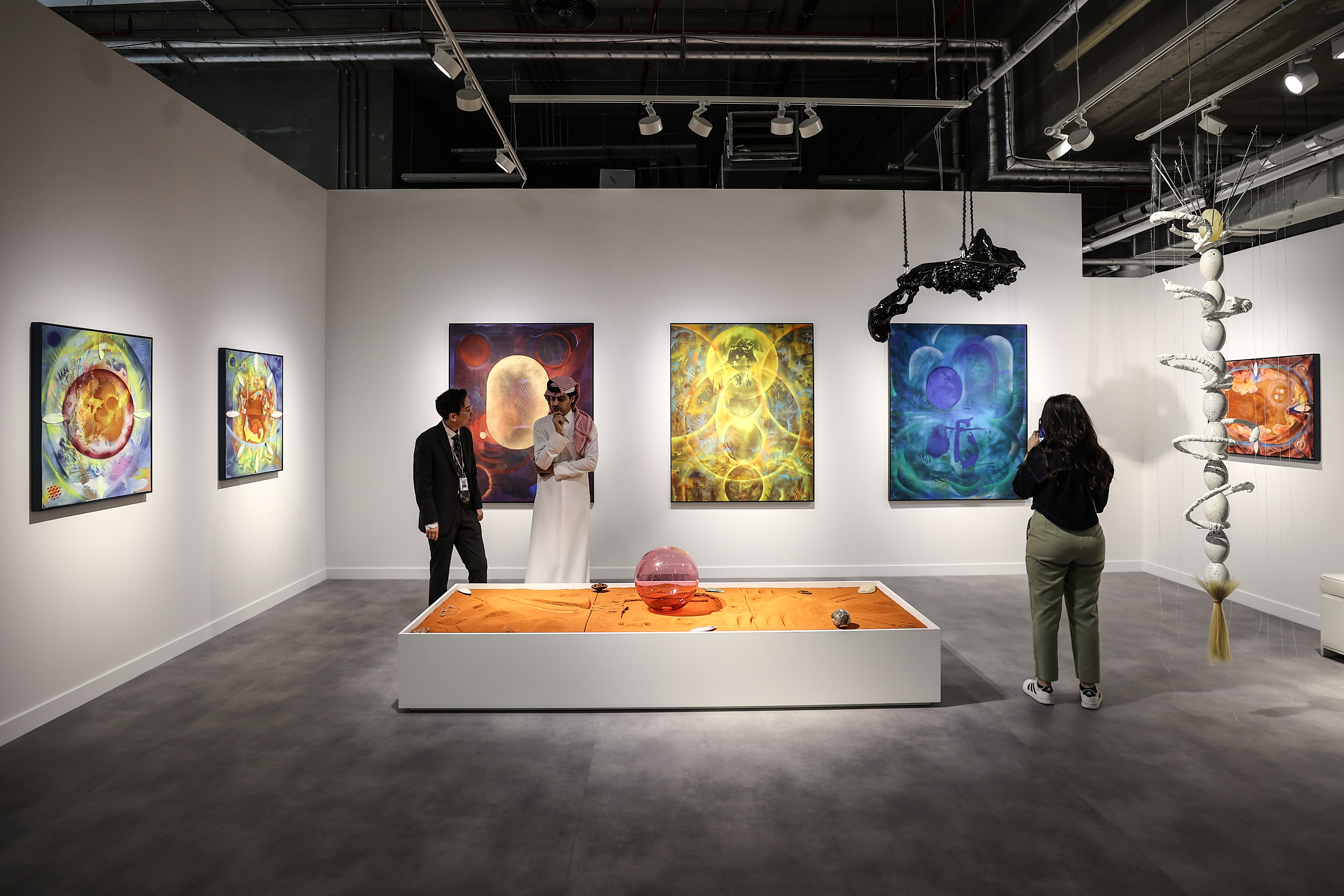 Visitors explore artworks and installations at the Art Basel Qatar Edition in Doha