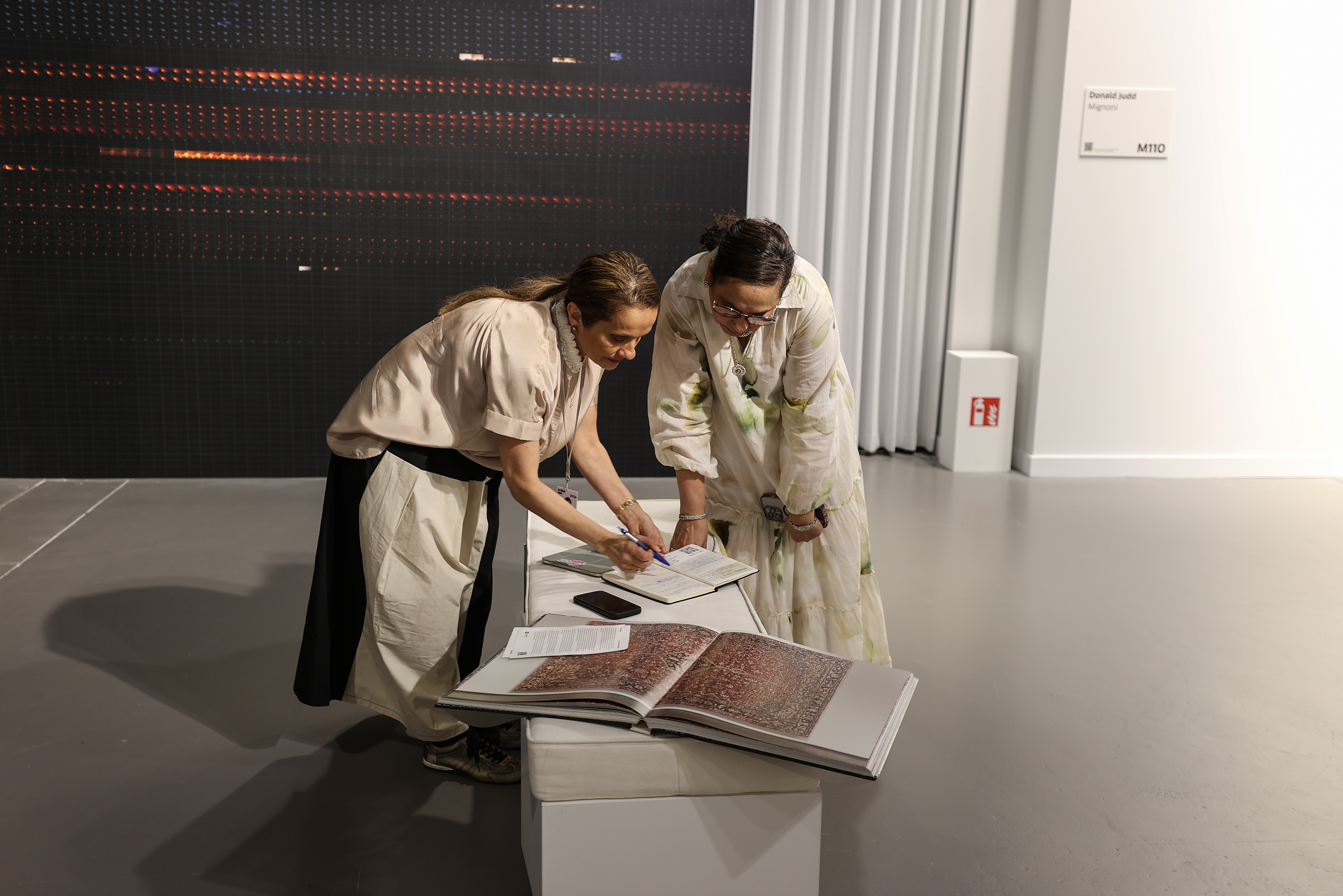 Visitors explore artworks and installations at the Art Basel Qatar Edition in Doha