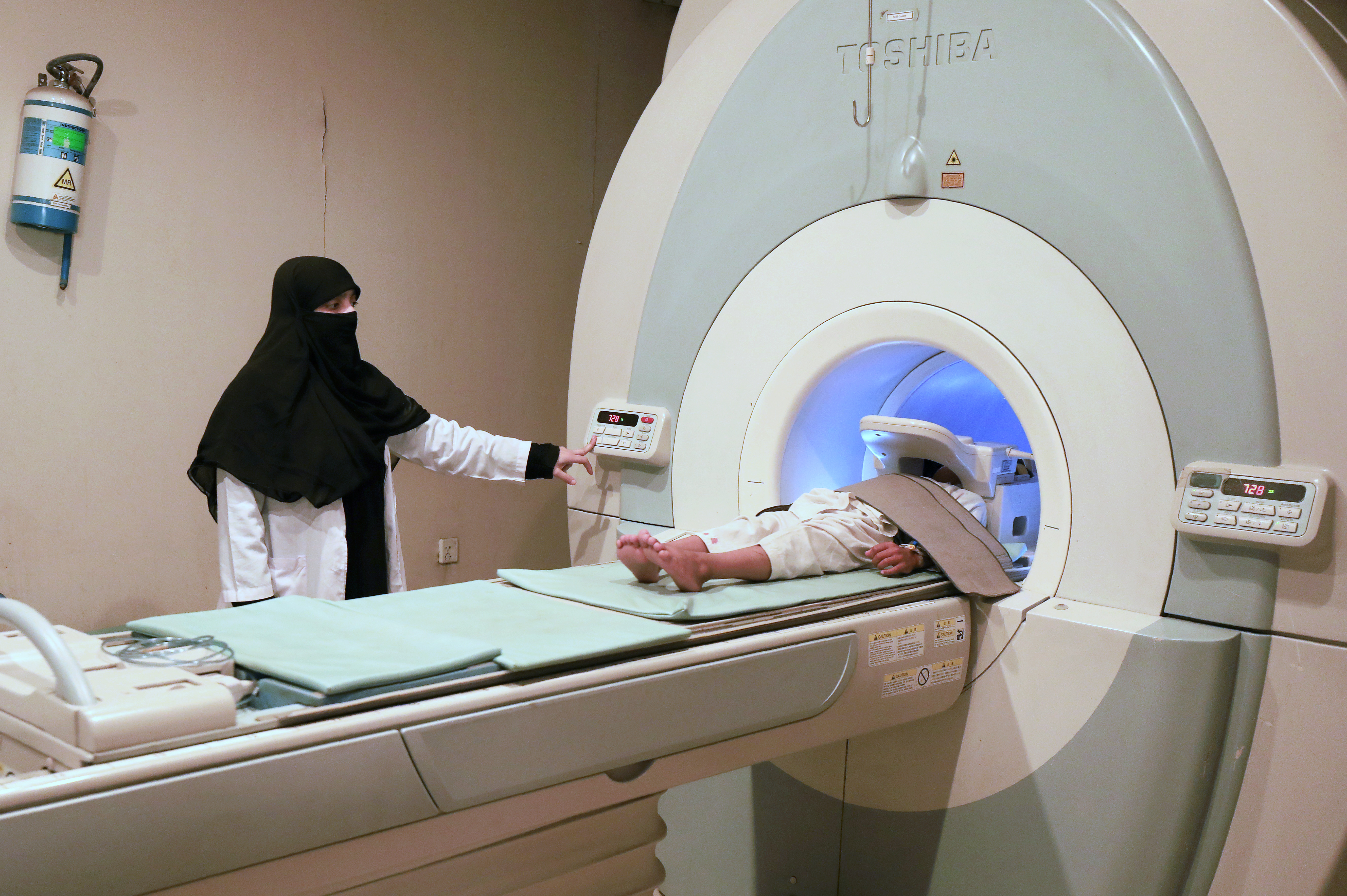 A patient goes through the scan machine for an MRI test.