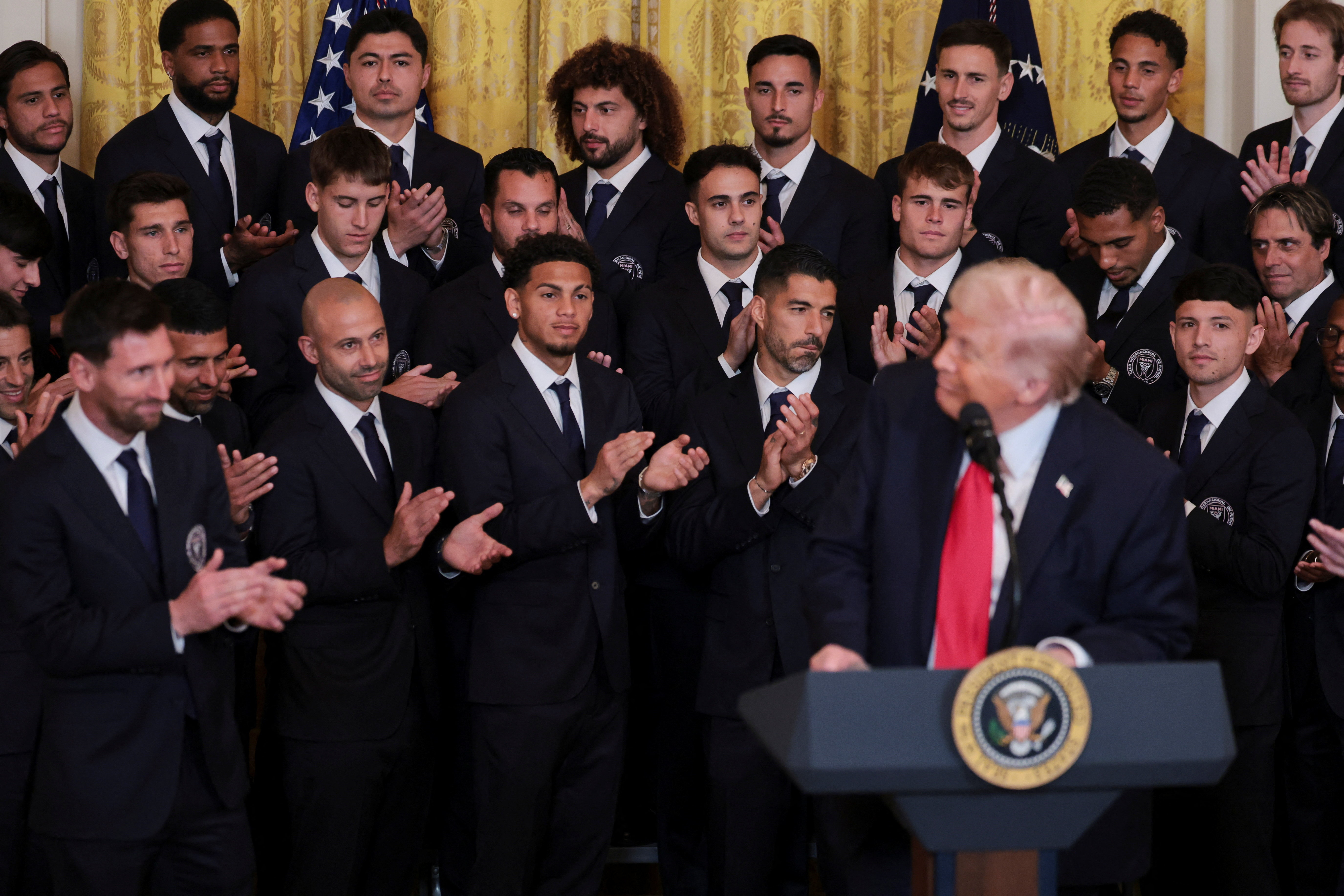 Inter Miami CF captain Lionel Messi and his team applaud while U.S. President Donald Trump speaks during an event to honor reigning Major League Soccer (MLS) champion Inter Miami CF players and team officials in the East Room of the White House
