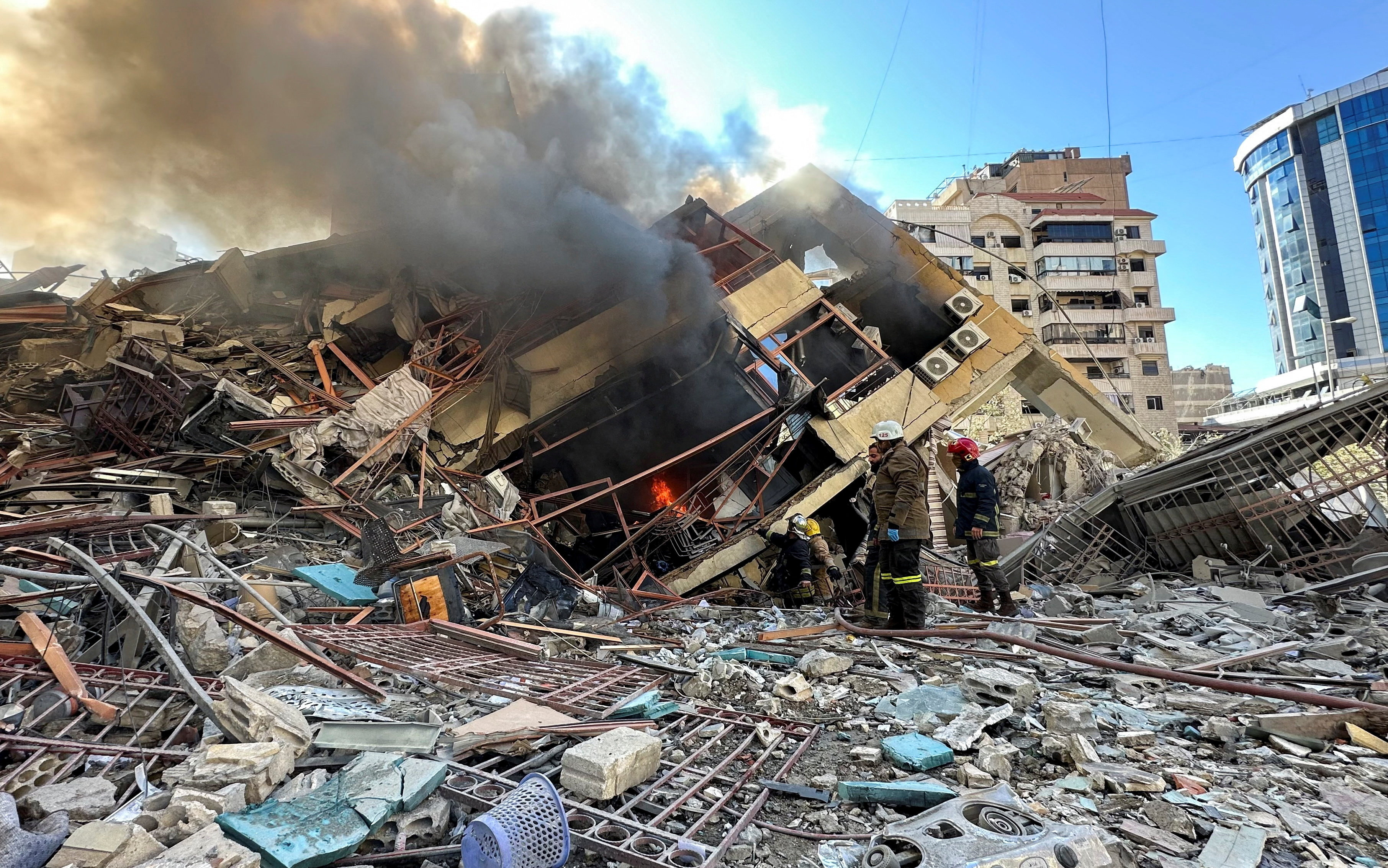 Members of the Lebanese Civil Defence inspect a damaged building after an Israeli strike on Beirut's southern suburbs, following renewed hostilities between Hezbollah and Israel amid the U.S.-Israeli conflict with Iran, Lebanon, March 9, 2026.