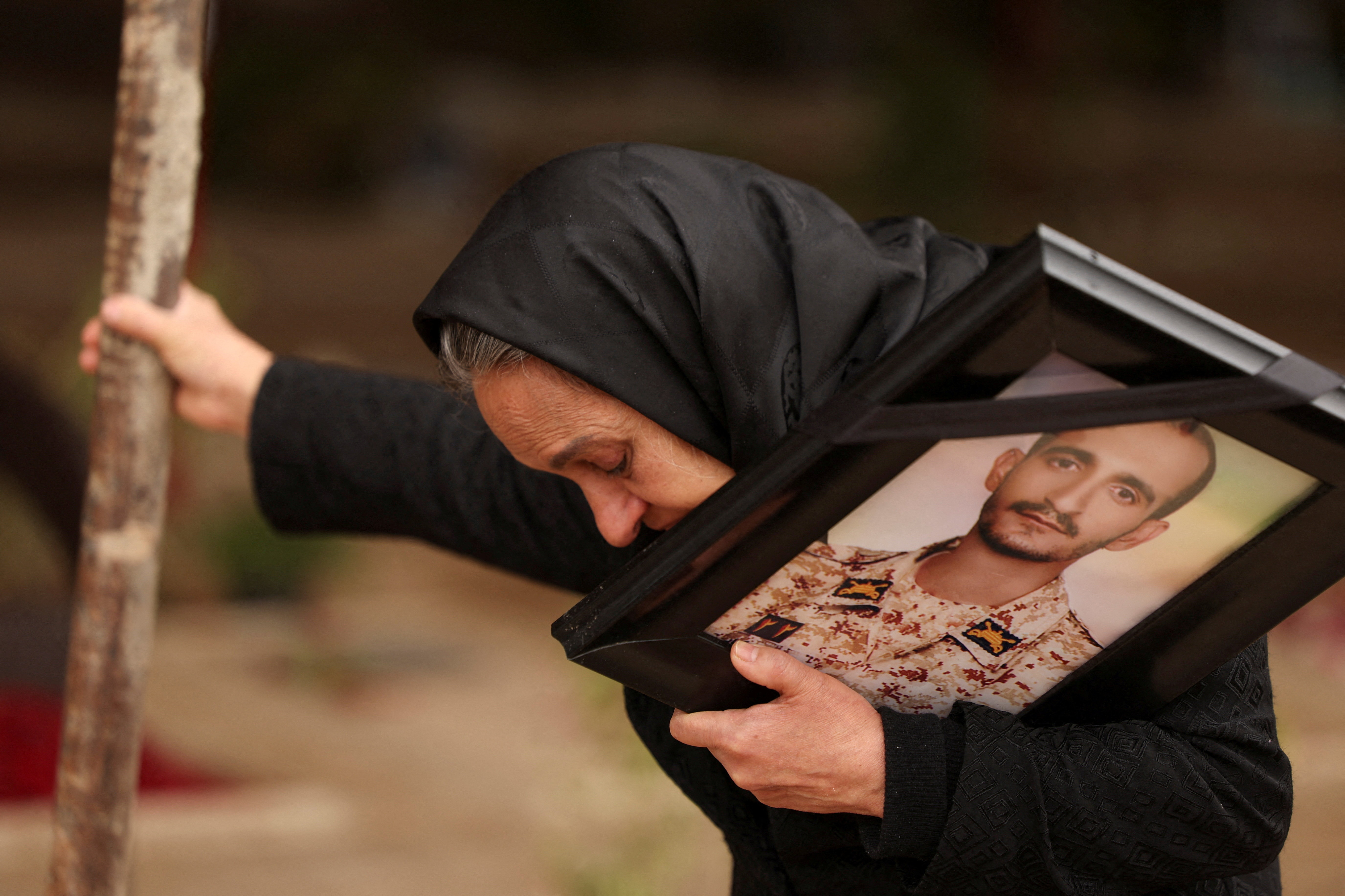 Marzia Rezaei reacts while standing near the grave of her son, Erfan, who was killed in strikes, amid the U.S.-Israeli conflict with Iran, at Behesht-e Zahra cemetery, in Tehran, Iran, March 16, 2026. REUTERS/Alaa Al-Marjani TPX IMAGES OF THE DAY