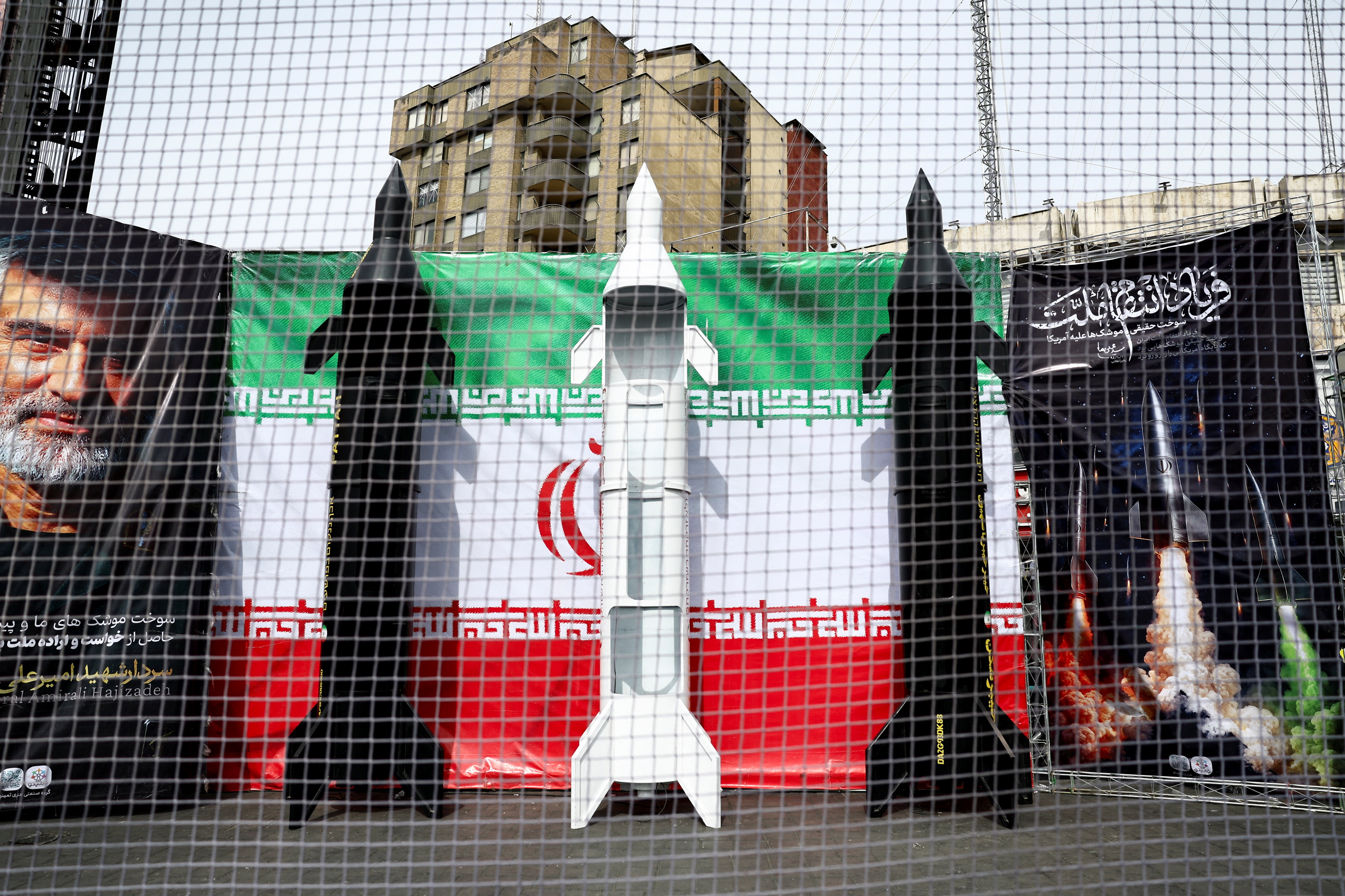 Symbolic mock-ups of Iranian missiles are displayed on a street.