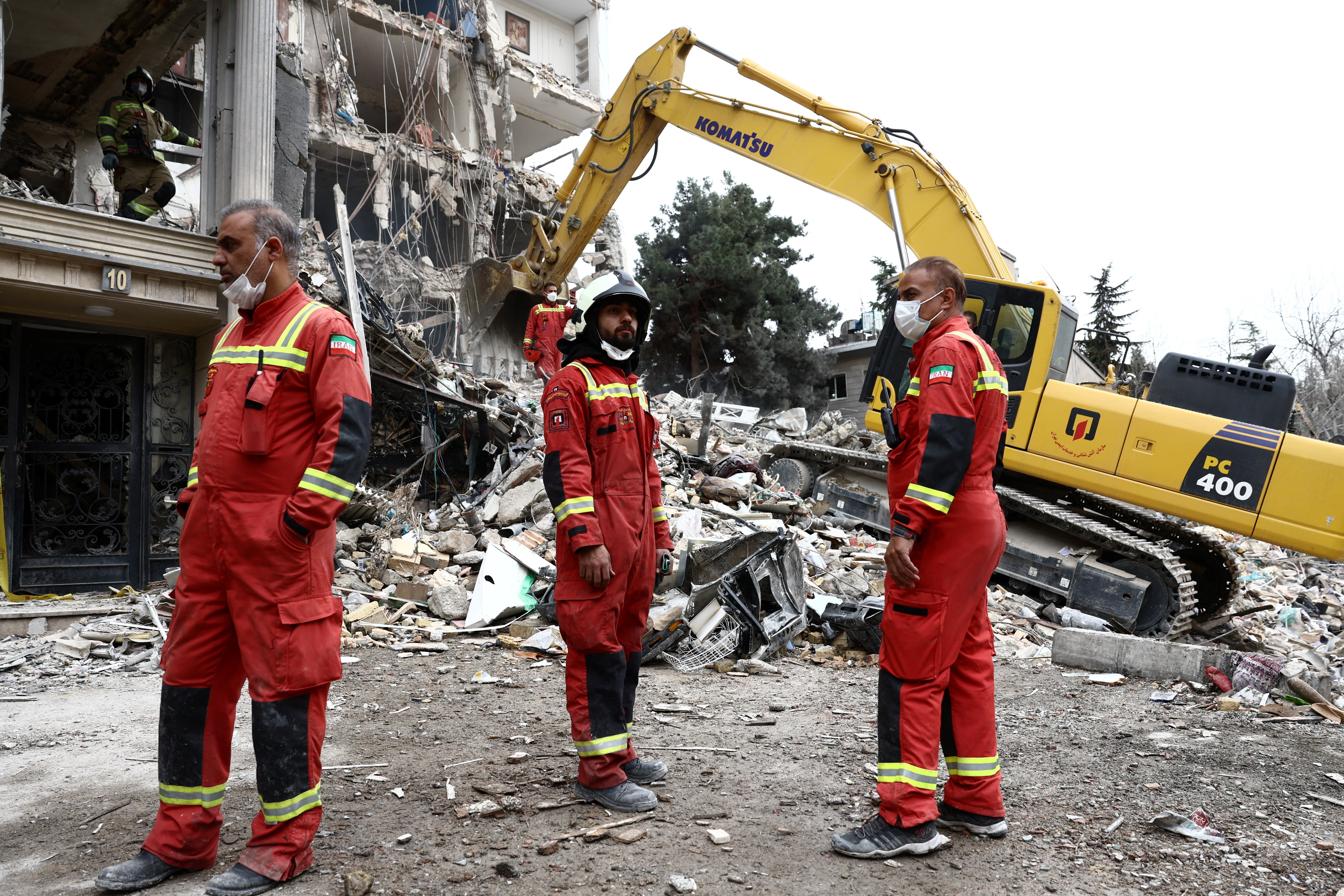 Emergency personnel work at the site of a strike on a residential building