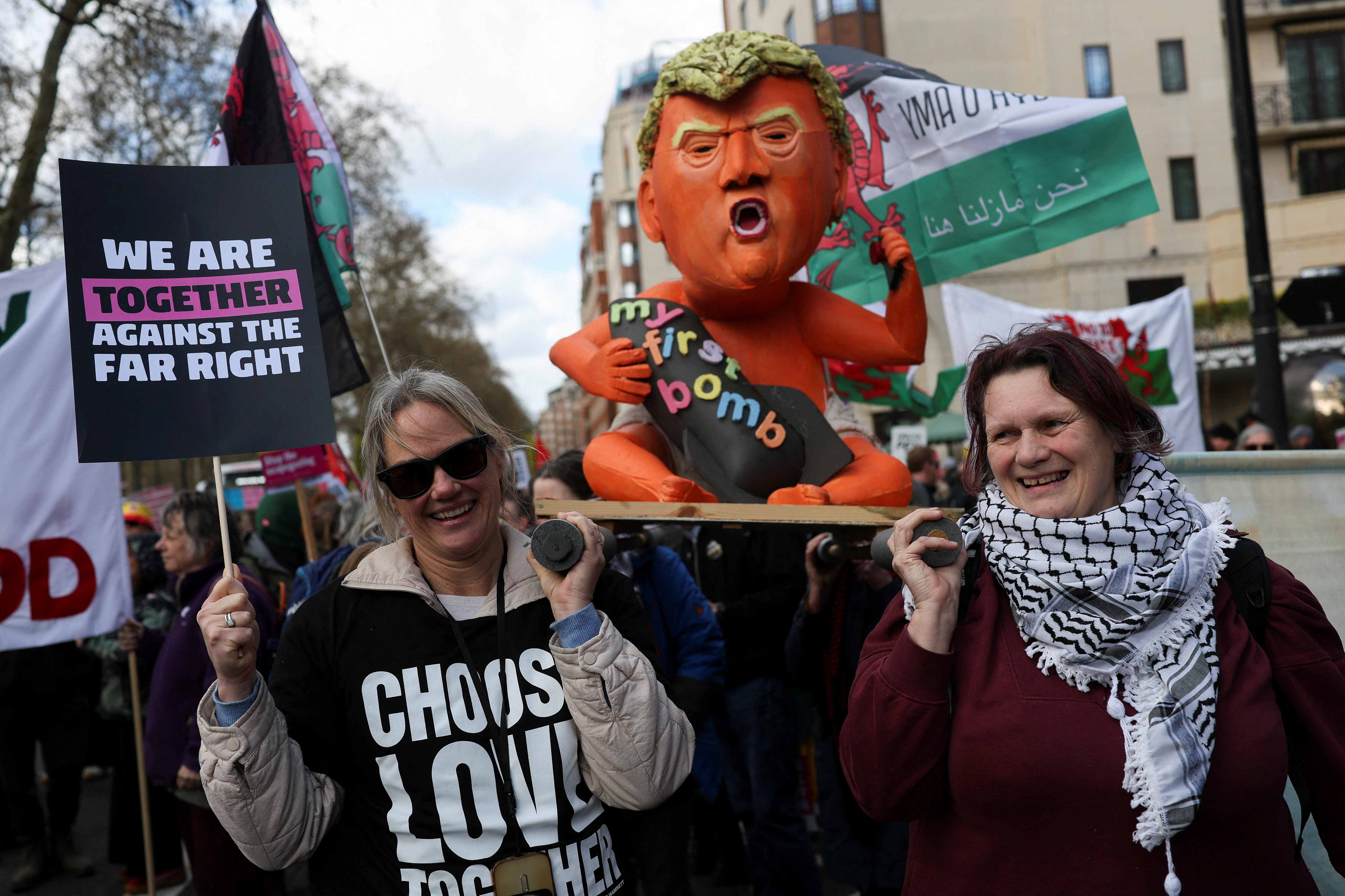 Demonstrators carry a figure depicting US President Donald Trump at the Together Alliance march in central London [Hannah McKay/Reuters]