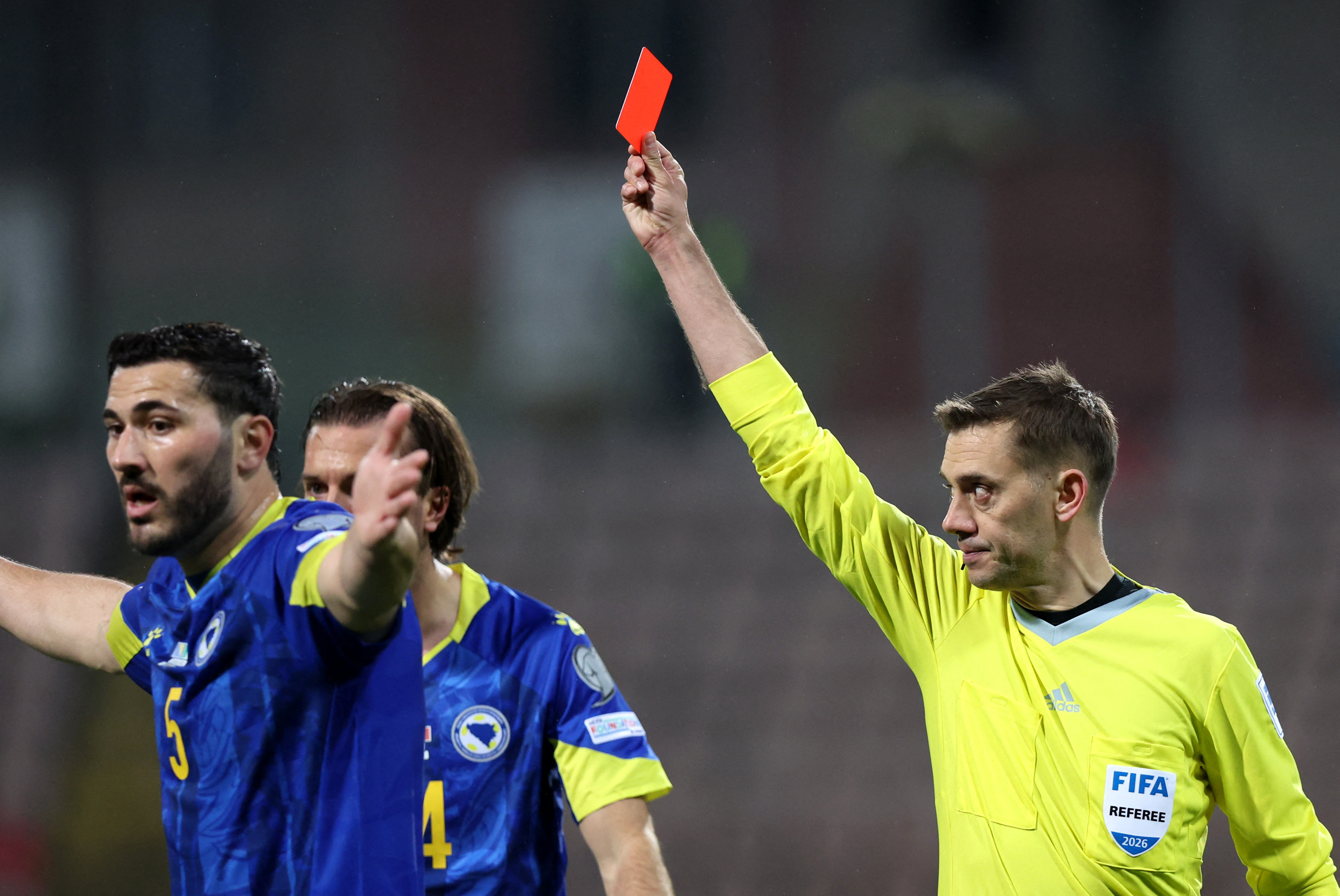 Italy's Alessandro Bastoni is shown a red card by referee
