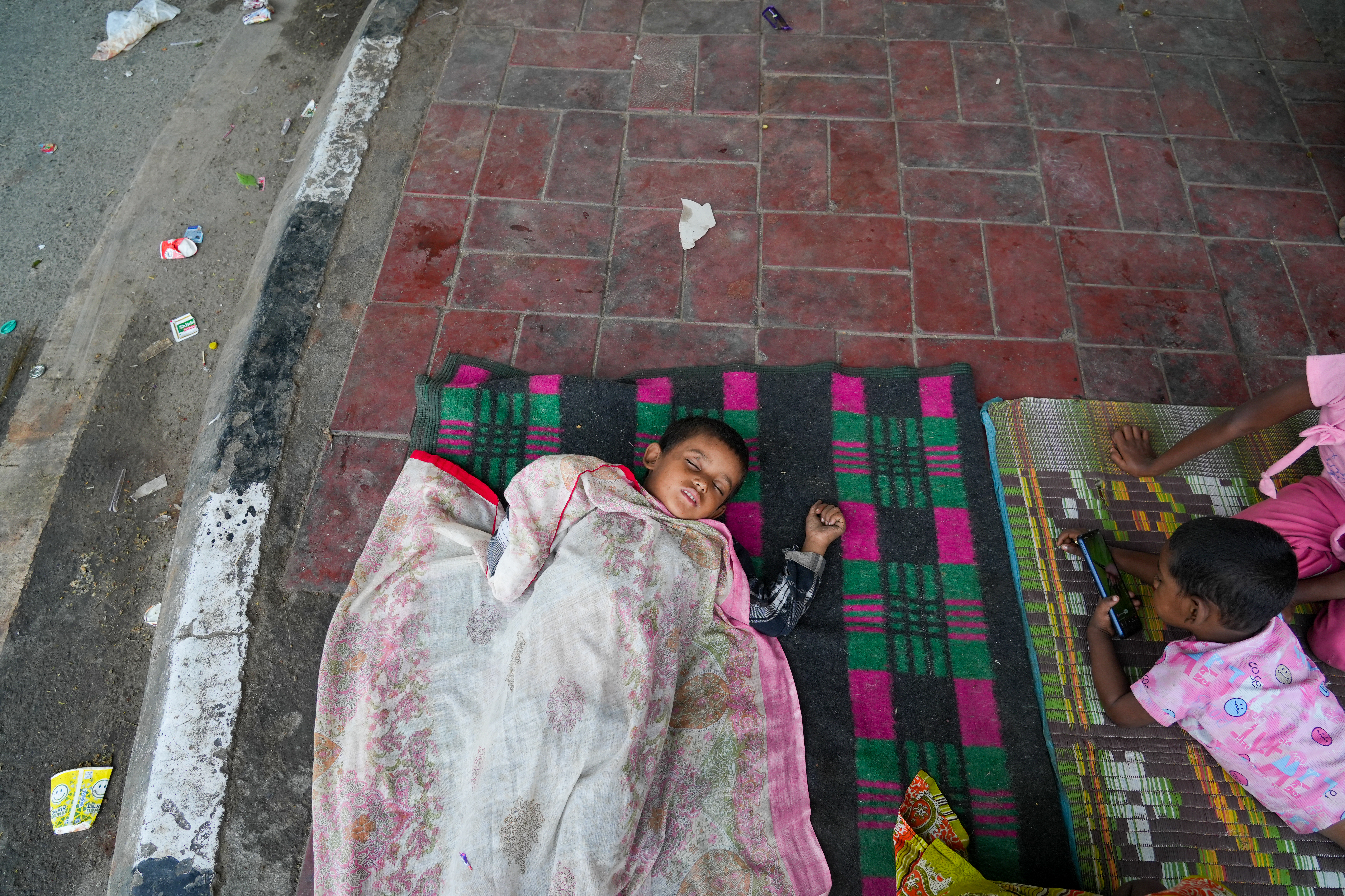 Every day, a fine layer of dust covers Abid’s children, clinging to their skin and clothes.Breathing it in makes them cough, weak, and often sick with fevers.The dusty streets never give them a moment of relief, even as they play or rest.Their small bodies struggle to fight illness, and Abid watches helplessly. [Suhail Bhat/Al Jazeera]
