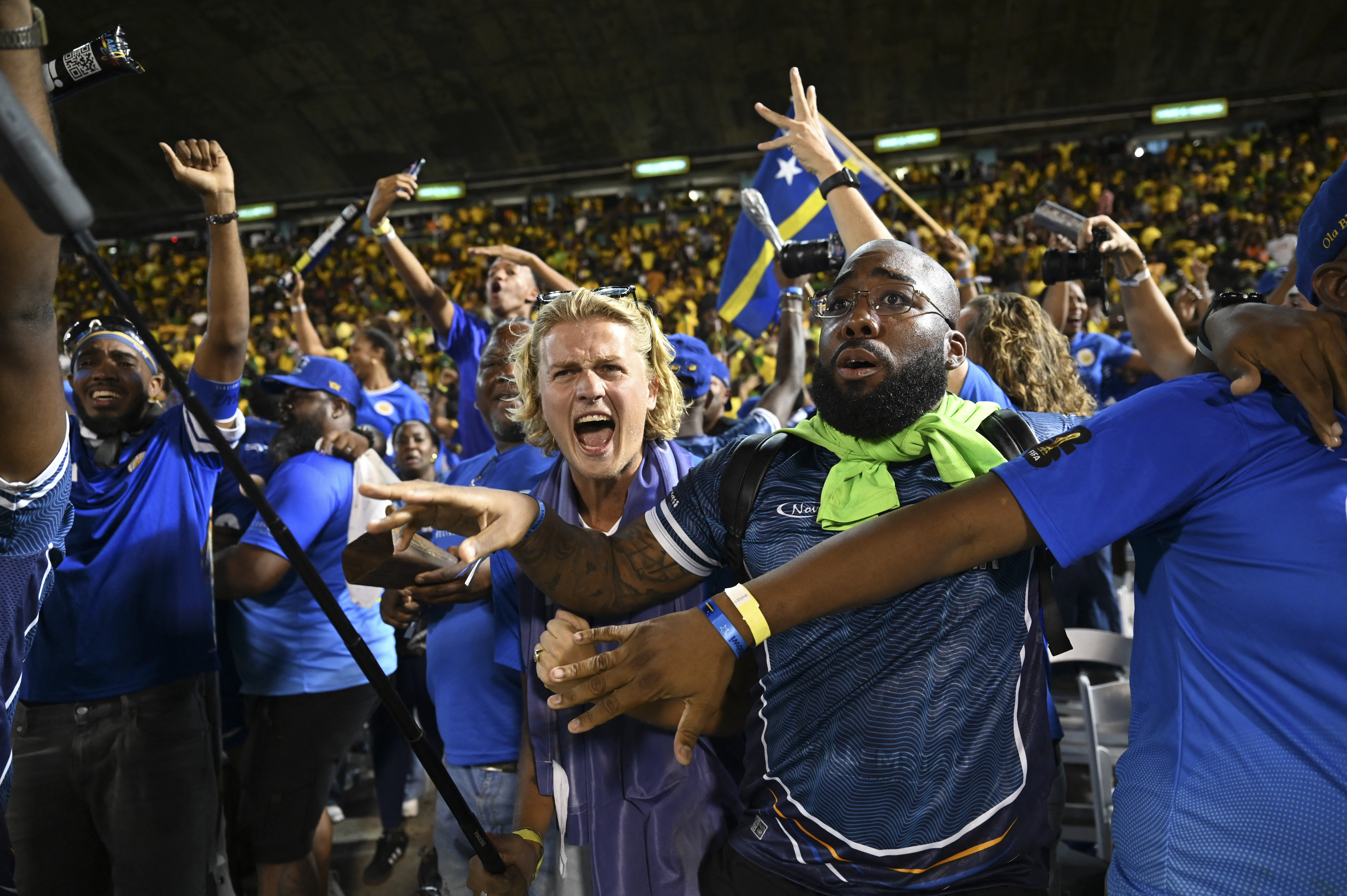 Curaçao fans celebrate World Cup 2026 qualification after a 0-0 draw with Jamaica at the National Stadium in Kingston, Jamaica on November 18, 2025. The tiny Caribbean nation of Curacao became the smallest country ever to qualify for the World Cup on November 18 as Haiti booked their return to the tournament for the first time in 52 years along with Panama.