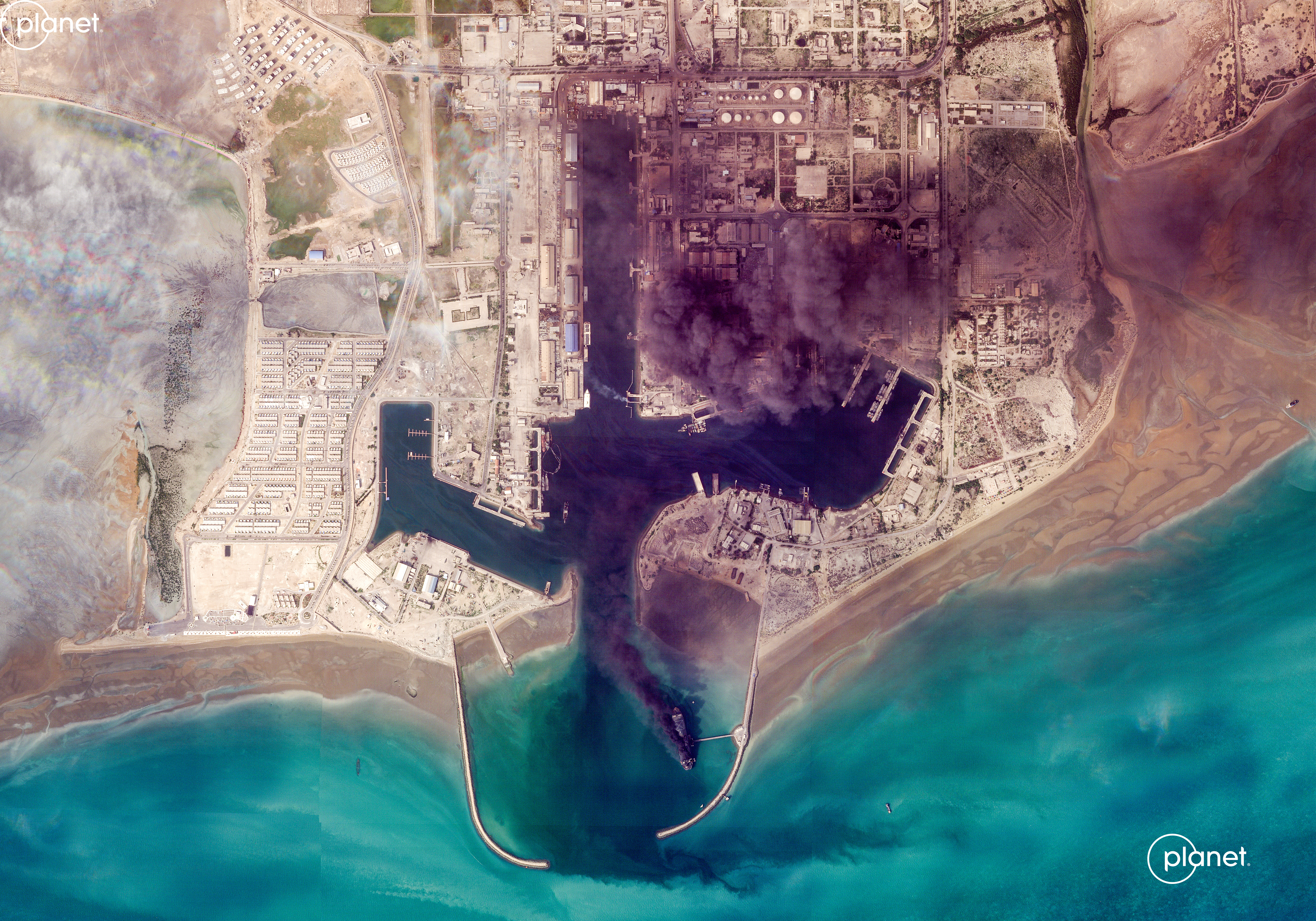 This handout satellite image taken by 2026 Planet Labs PBC on March 2, 2026 shows smoke billowing following an explosion from the port of Bandar Abbas along the strait of Hormuz. The United States and Israel launched strikes against Iran on February 28, killing Iran's supreme leader and top military leaders, prompting authorities to retaliate with strikes on Israel and US bases across the Gulf. (Photo by 2026 Planet Labs PBC / AFP) / RESTRICTED TO EDITORIAL USE - MANDATORY CREDIT "AFP PHOTO / © 2026 PLANET LABS PBC " - HANDOUT - NO MARKETING NO ADVERTISING CAMPAIGNS - DISTRIBUTED AS A SERVICE TO CLIENTS