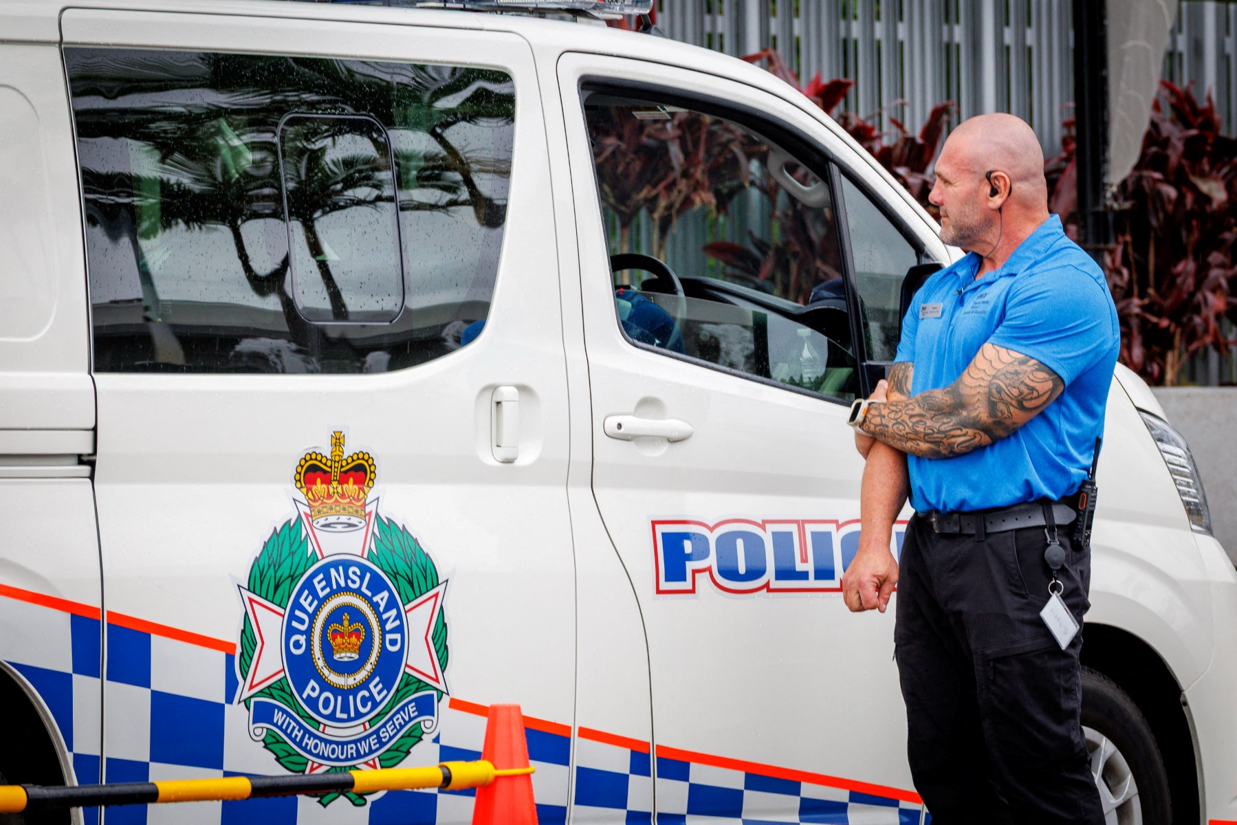 A hotel security member stands beside a police van at the entrance to the Royal Pines Resort, where members of the Iranian womens football team are staying, on the Gold Coast on March 9, 2026. Australia must protect the visiting Iranian women's football team, the son of the nation's late shah urged March 9, warning their refusal to sing the national anthem before a match could have "dire consequences". (Photo by Patrick HAMILTON / AFP)