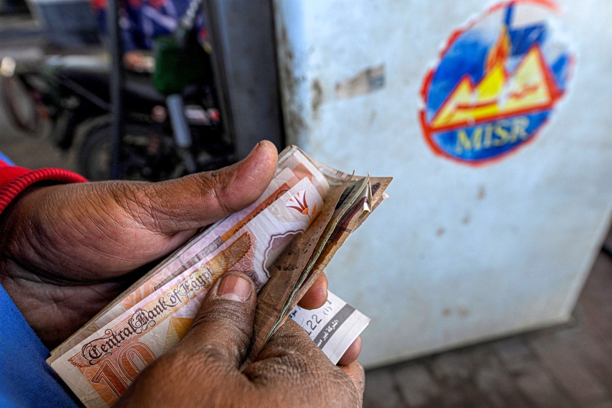 A worker counts banknotes.