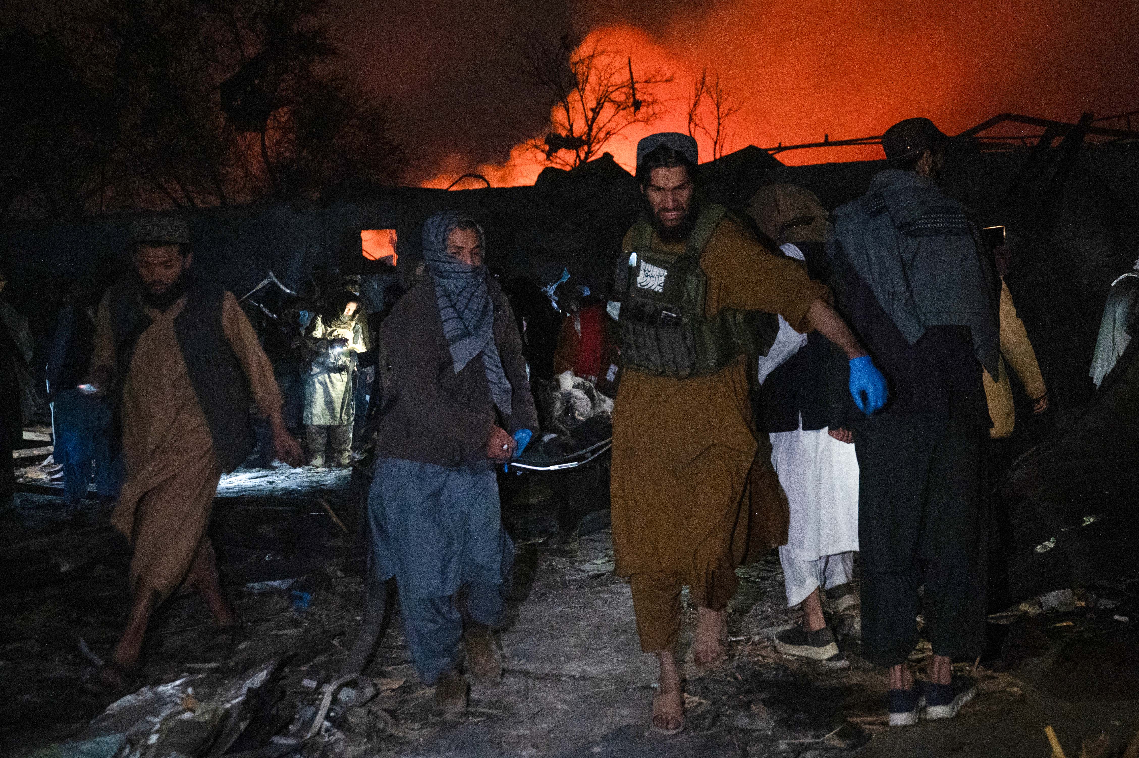 Taliban security personnel carry a body at the site of a damaged building after Pakistani airstrikes allegedly hit the Secondary Rehabilitation Services Centre in Kabul on March 16, 2026. [Wakil Kohsar/ AFP]