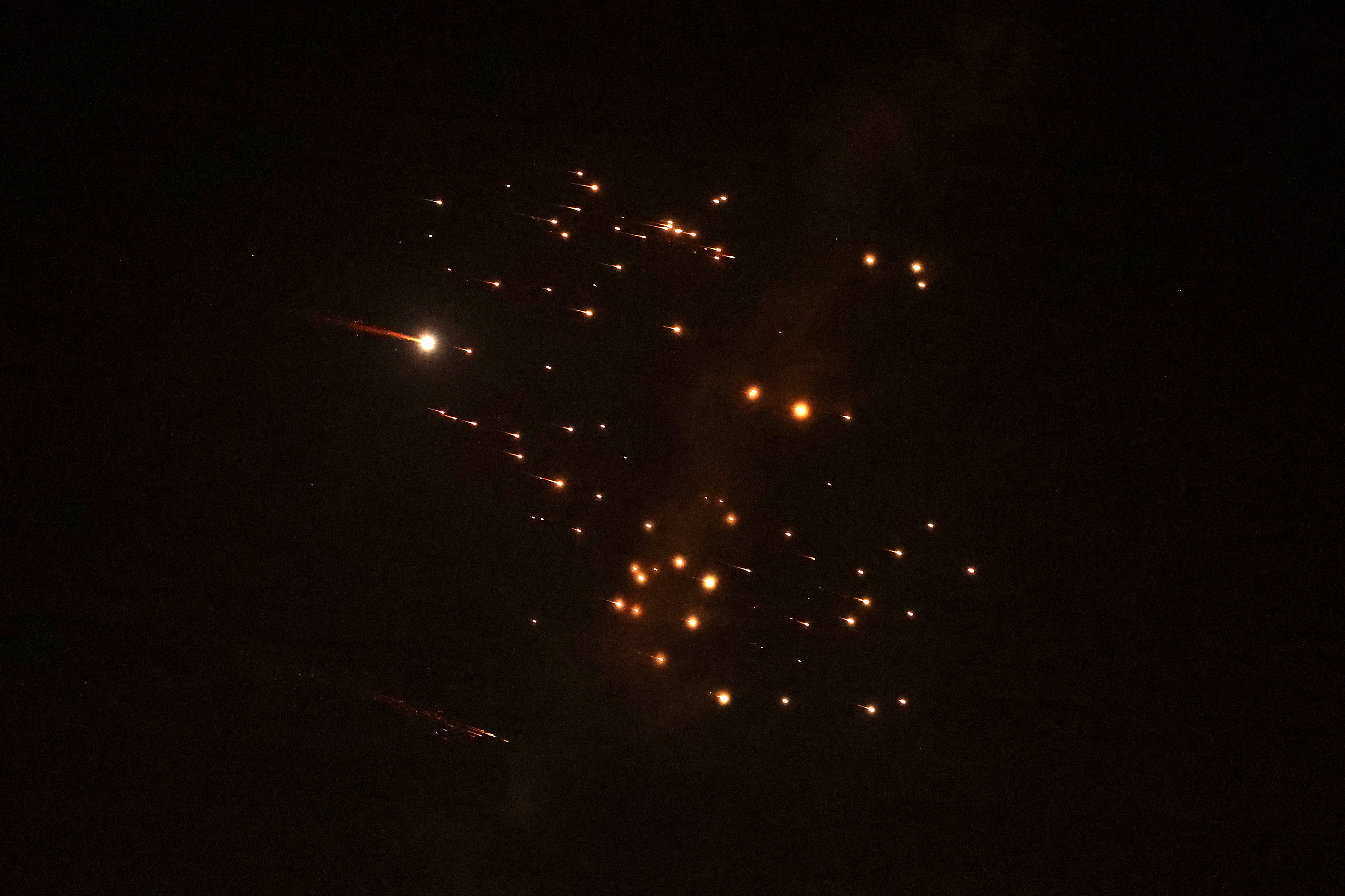 Rocket trails are seen in the sky amid a barrage of missile attacks.