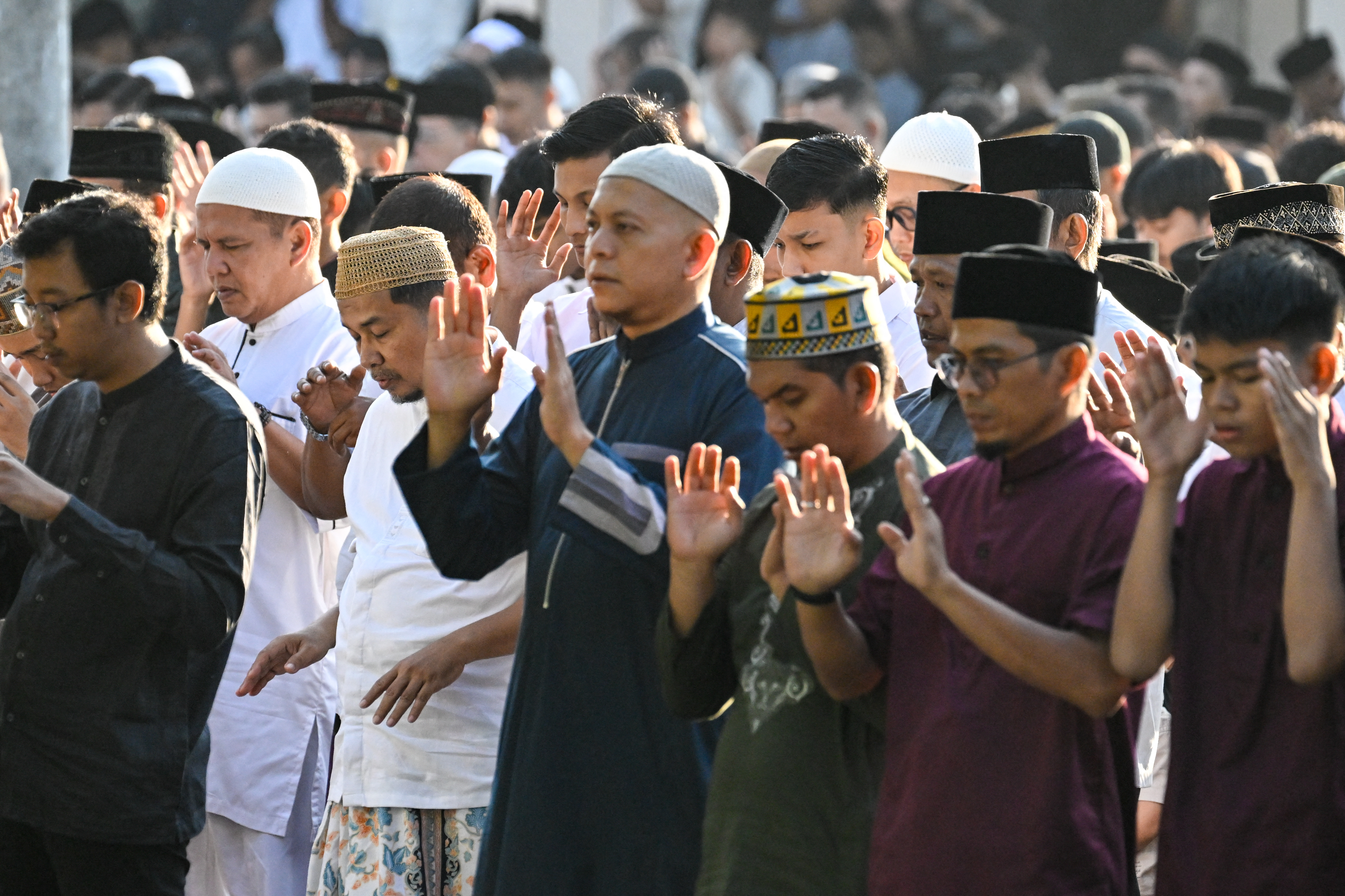 Muslim devotees take part in a morning prayer celebrating Eid al-Fitr, which marks the end of the holy month of Ramadan, in the compounds of the Muhammadiyah University in Banda Aceh on March 20, 2026. (Photo by CHAIDEER MAHYUDDIN / AFP/Chaideer MAHYUDDIN / AFP)