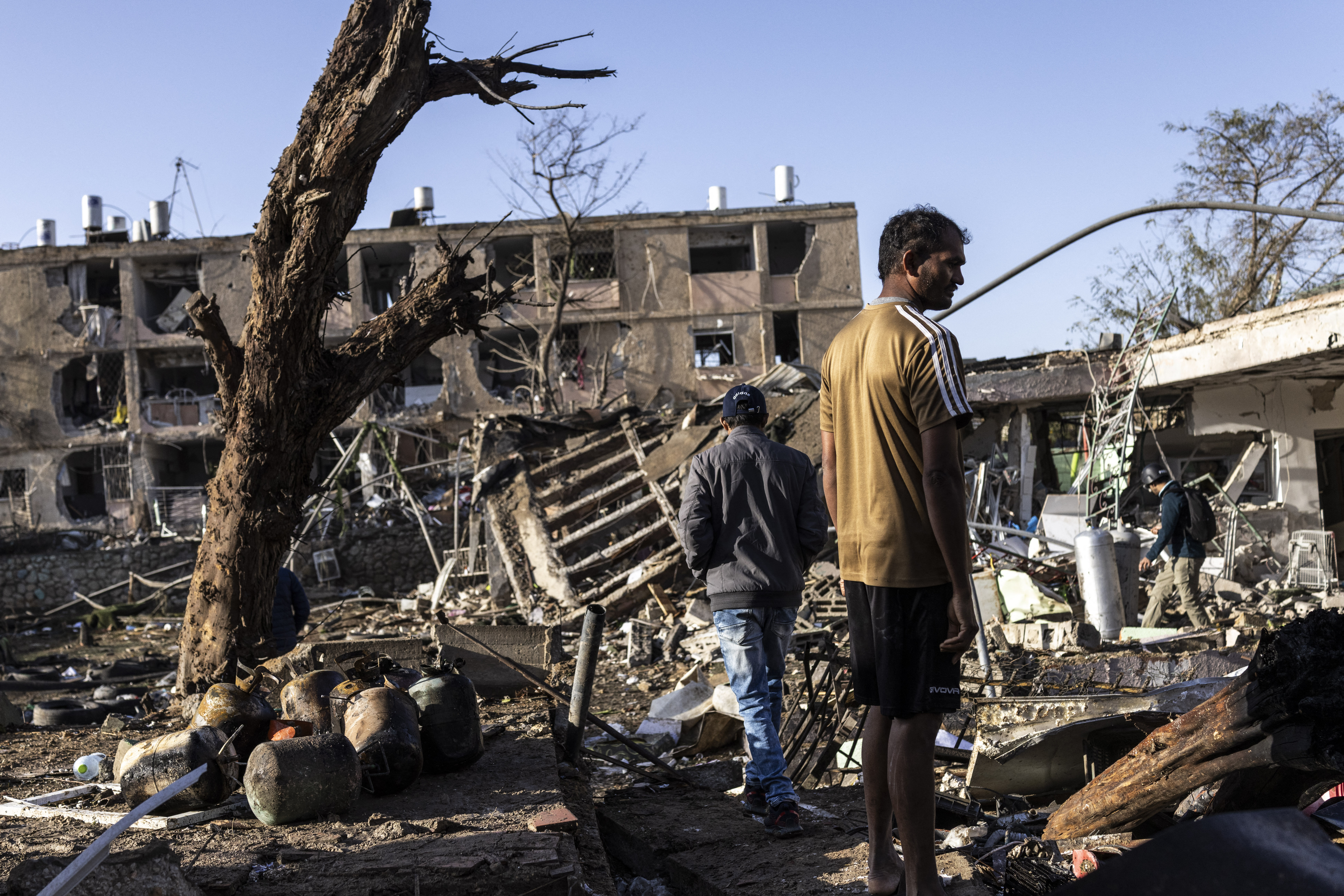 People inspect the site of an Iranian missile strike in Dimona