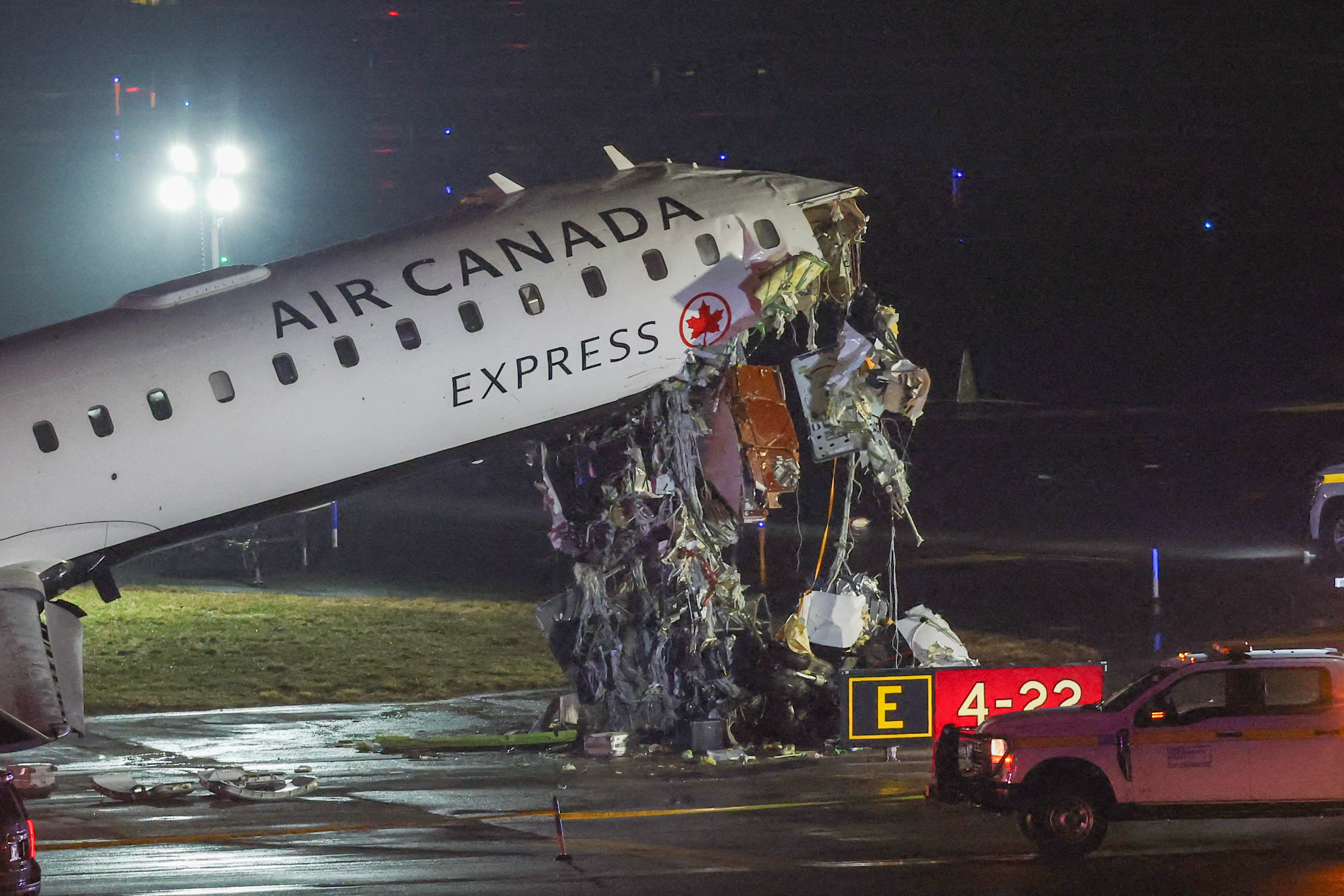 An Air Canada Express CRJ-900 sits on the runway after colliding with a Port Authority fire truck at LaGuardia airport, New York