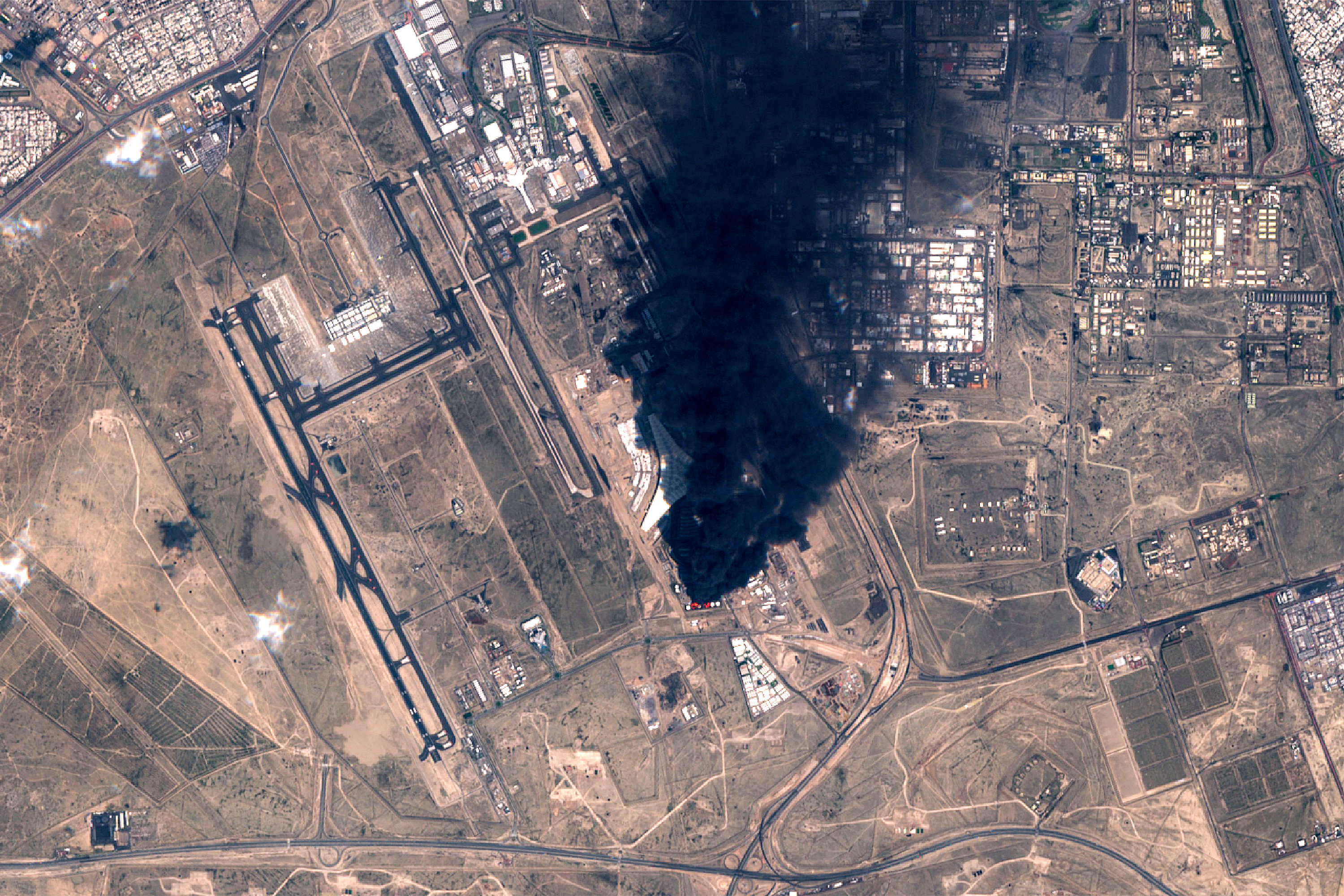 This handout image taken by the European Space Agency (ESA) captured by the Copernicus Sentinel-2 satellite shows a view of smoke plumes billowing in the vicinity Kuwait International Airport on March 25, 2026.