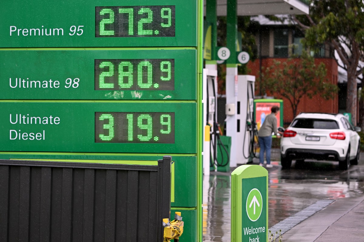 Fuel prices are displayed at a petrol station.