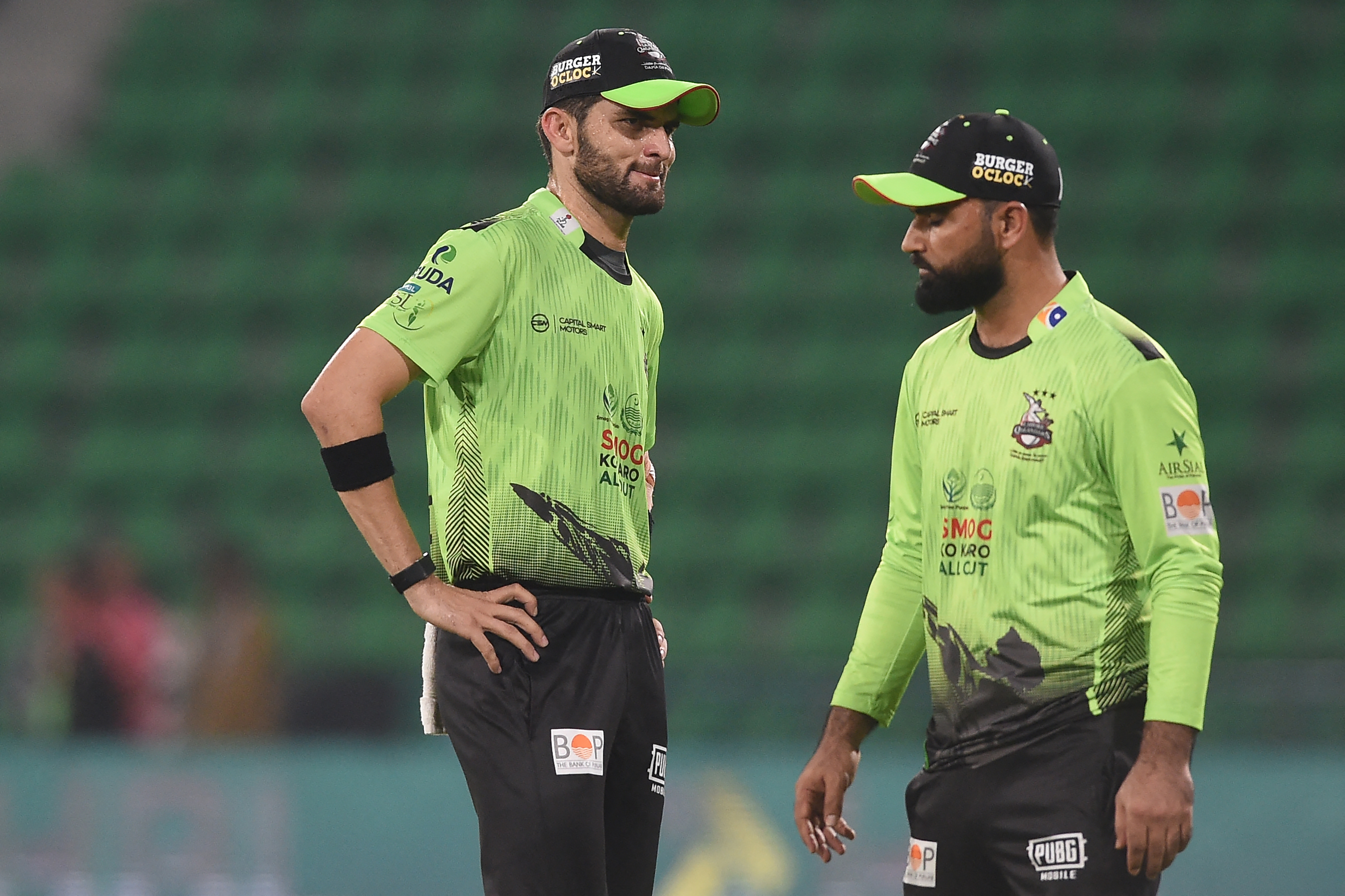Lahore Qalandars' captain Shaheen Shah Afridi (L) speaks with teammate Fakhar Zaman (R) during the Pakistan Super League (PSL) T20 match between Karachi Kings and Lahore Qalandars at the Gaddafi Cricket Stadium in Lahore on March 29, 2026. Lahore Qalandars' Fakhar Zaman could face a ban after being charged with a ball-tampering offence in his side's defeat to Karachi Kings in the T20 Pakistan Super League. (Photo by Syed Murtaza Ali / AFP)