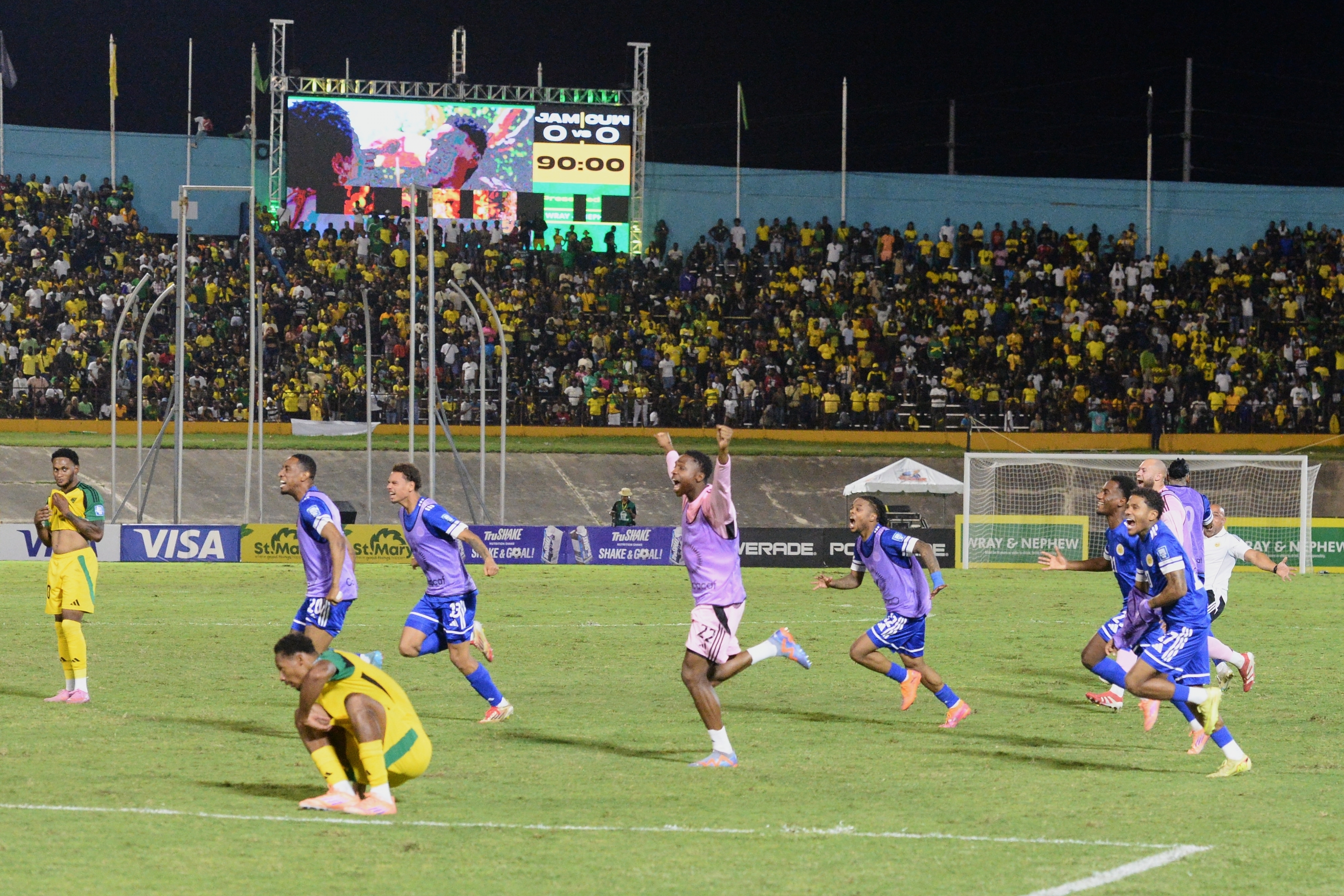 Curacao's players burst into celebrations after holding Jamaica to a goalless draw, a result which confirmed their World Cup qualification [File: Collin Reid/AP]