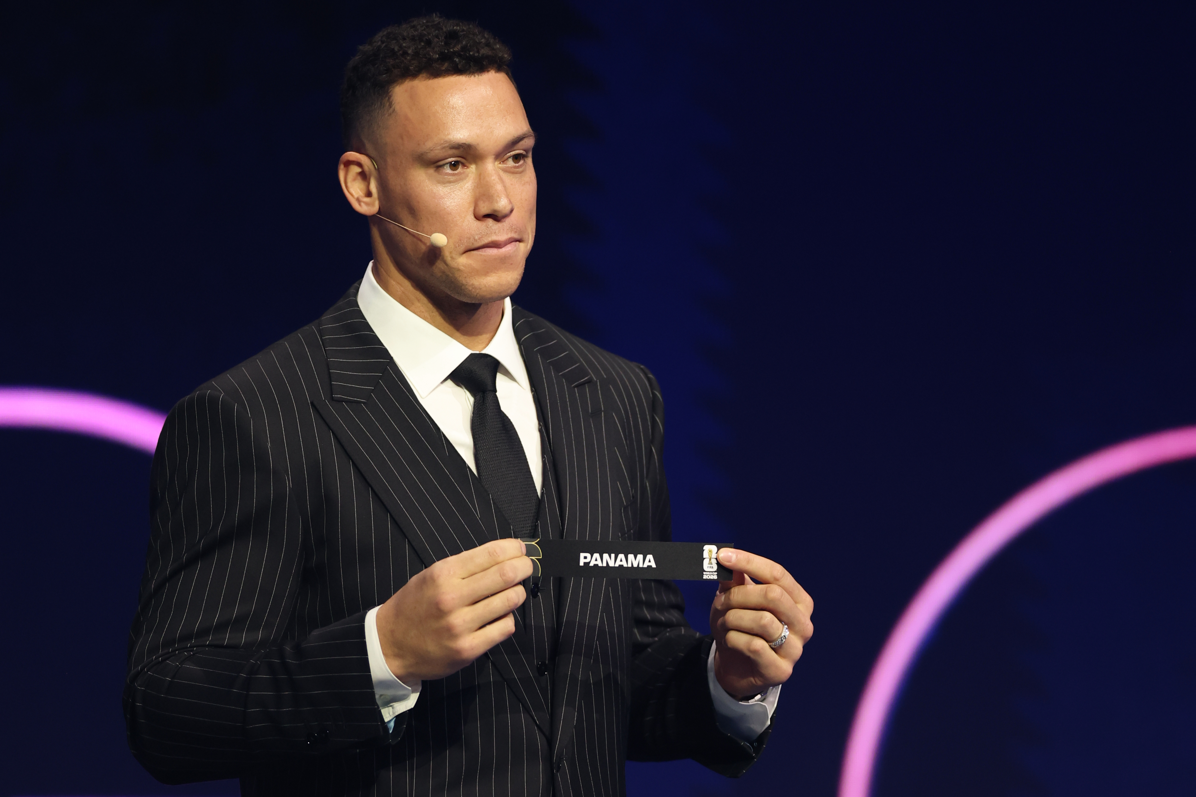 New York Yankees' Aaron Judge displays Panama during the draw for the 2026 soccer World Cup at the Kennedy Center in Washington, Friday, Dec. 5, 2025. (Dan Mullan/Pool Photo via AP)