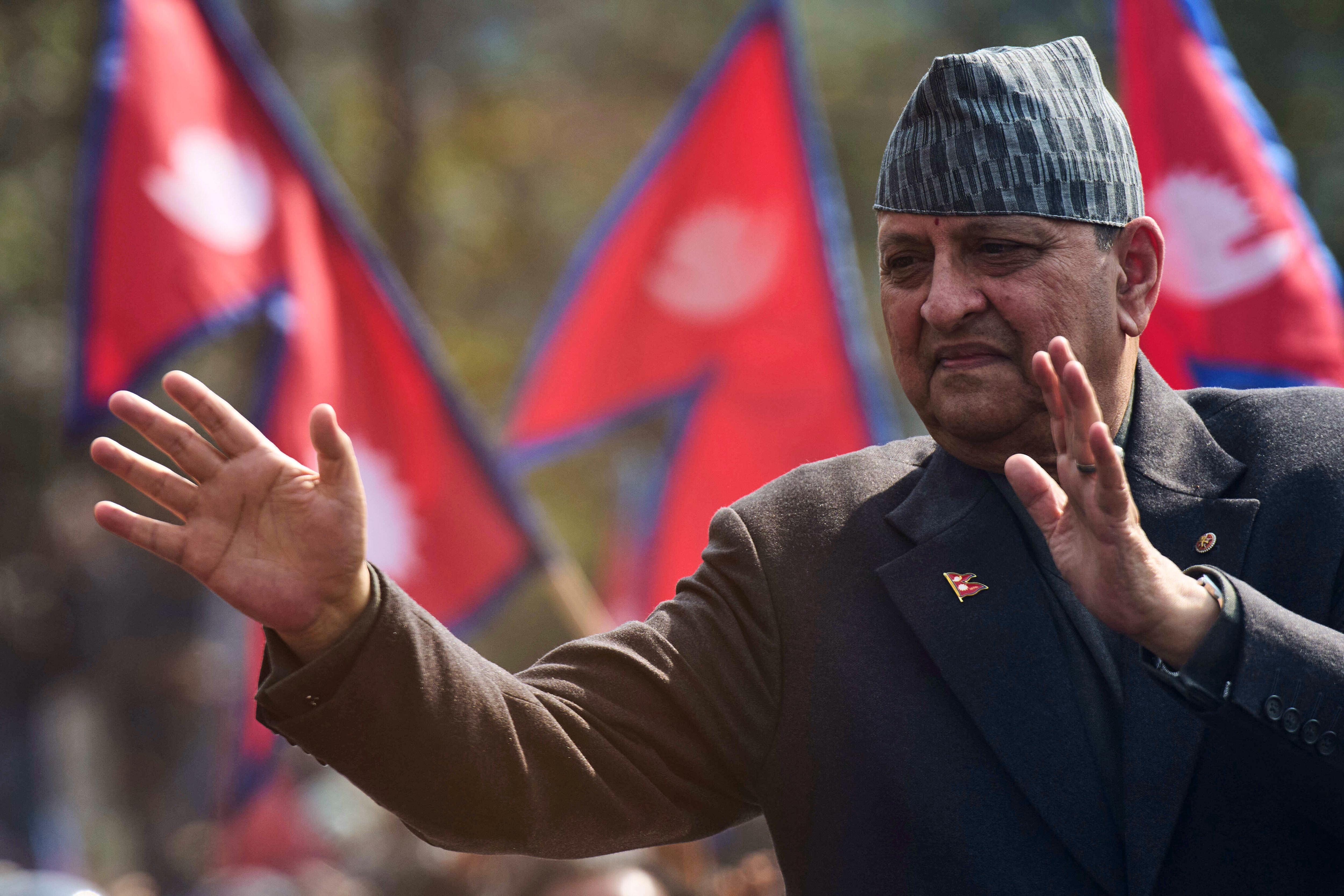 Former King Gyanendra Shah waves to his supporters upon his arrival at Tribhuvan International Airport in Kathmandu, Nepal, Friday, Feb. 13, 2026. (AP Photo/Niranjan Shrestha)