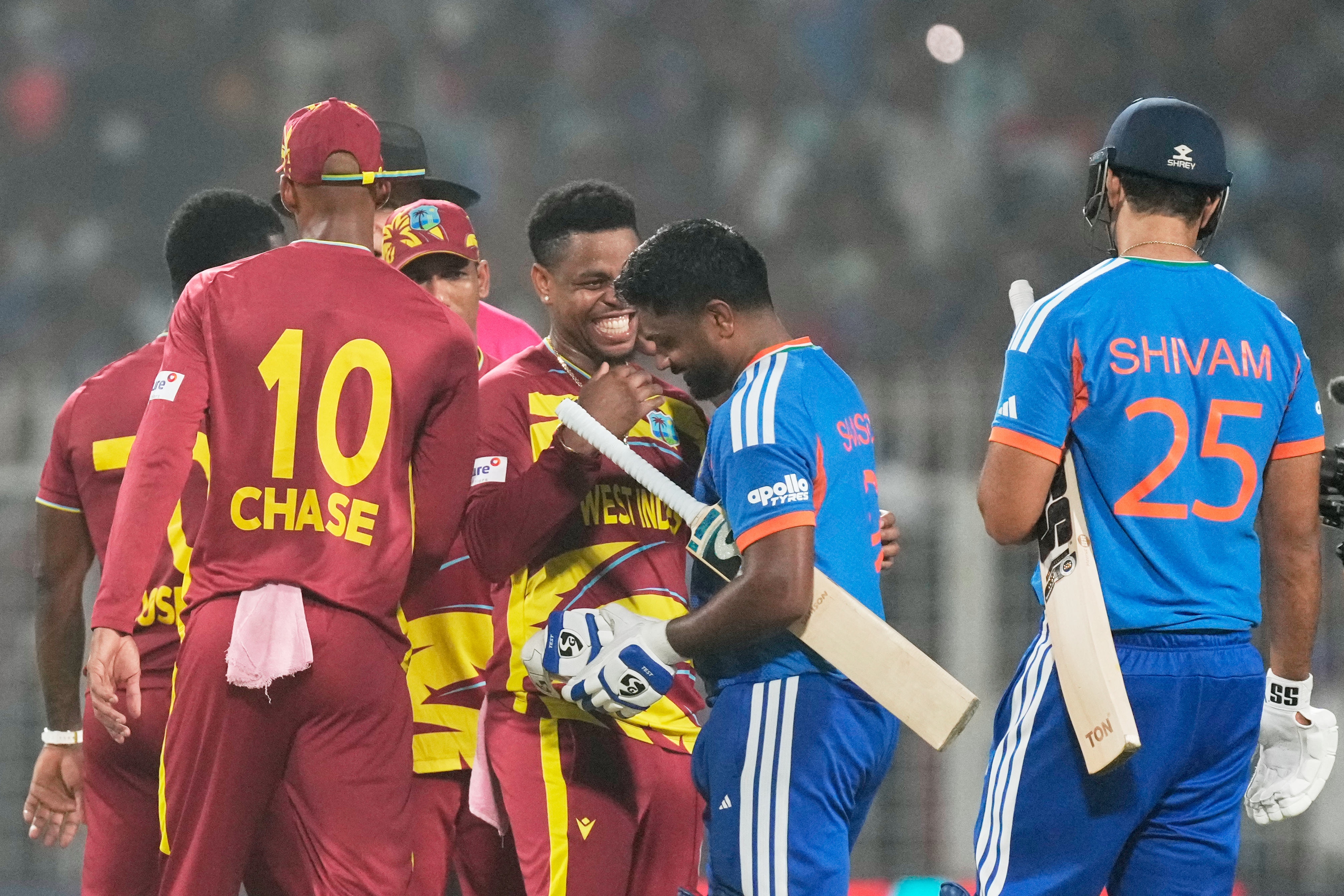 West Indies' Shimron Hetmyer, center, chats with India's Sanju Samson after India won the T20 World Cup cricket match against West Indies in Kolkata, India, Sunday, March 1, 2026. (AP Photo/Bikas Das)