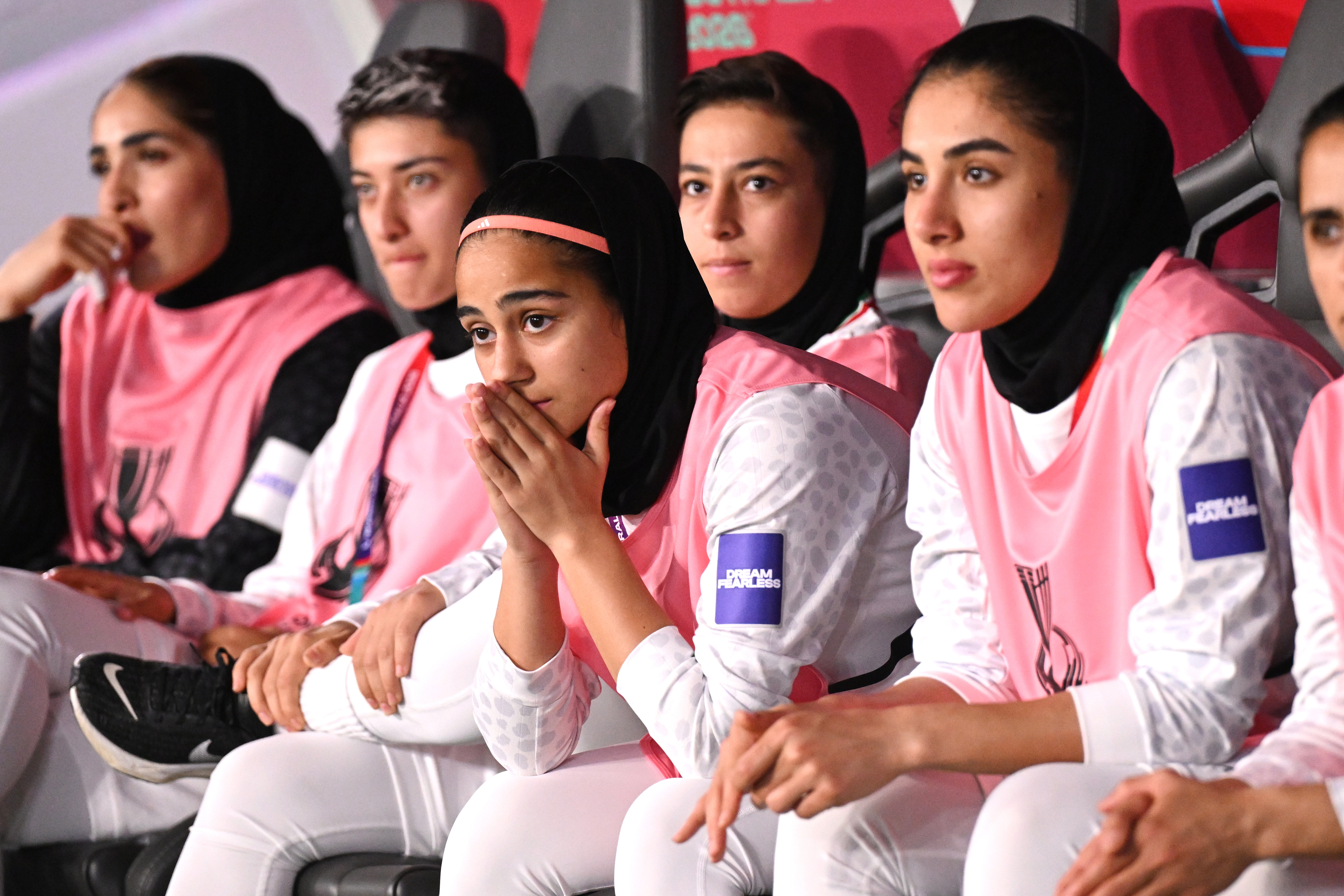 Iranian players react from the bench during a match.