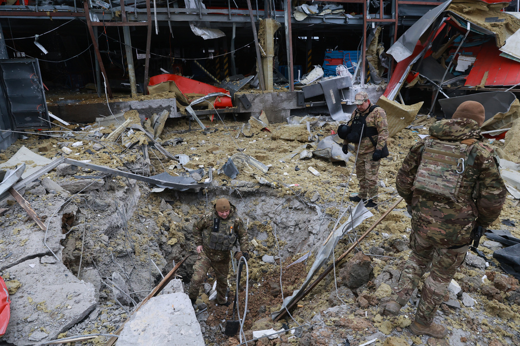 Sappers examine the site of a Russian missile strike on Zaporizhzhia