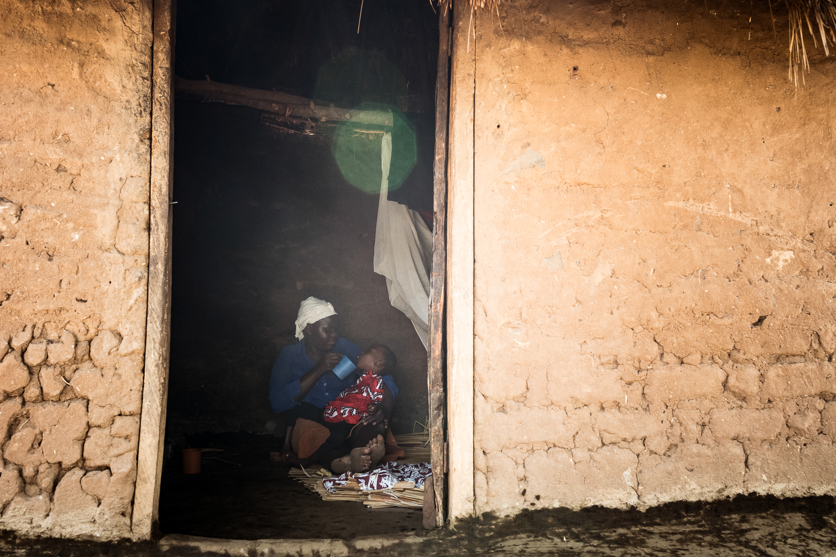 9th February 2026. Owalai, Uganda. Martha Apolot, 21 feeds her son Aaron Elayu, 8. Aaron lives with an undiagnosed disability and can only eat liquid foods, in this case boiled water with some sugar. He is cared for solely by his young mother Martha after she fell pregnant in dubious circumstances at age 13. She has been shunned by her family and recieves little assistance from them. Photograph by Christopher Hopkins