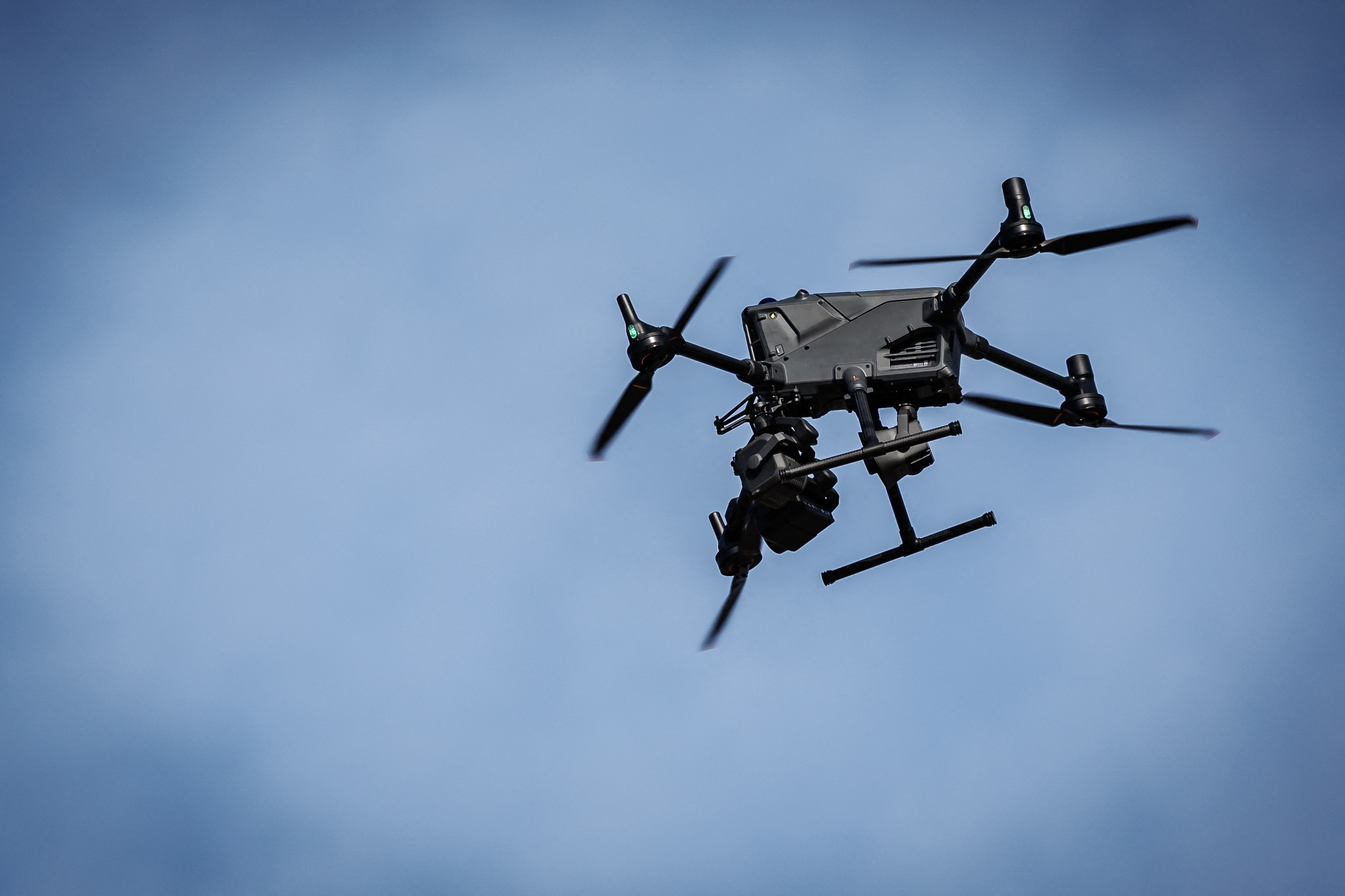 This photograph shows a surveillance drone hovering as Belgian police showcase their units deployed to tackle immigration, on the sidelines of a working visit by Belgium's Interior Minister and Britain's Border Security and Asylum minister, along the West Coast in Adinkerke on March 12, 2026.