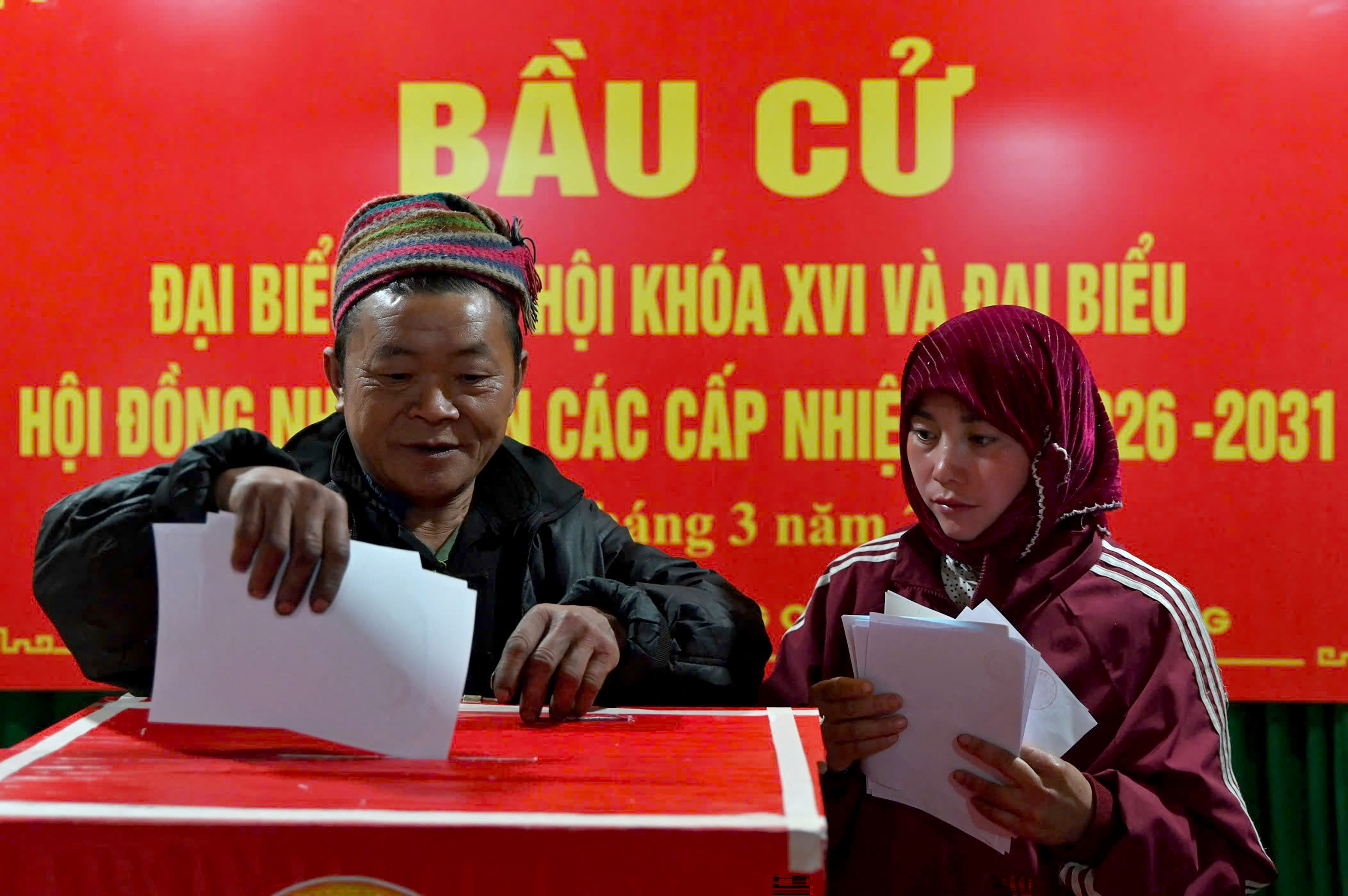 Ethnic minority citizens cast their votes inside a polling station in the northern Vietnamese province of Tuyen Quang on March 15, 2026.