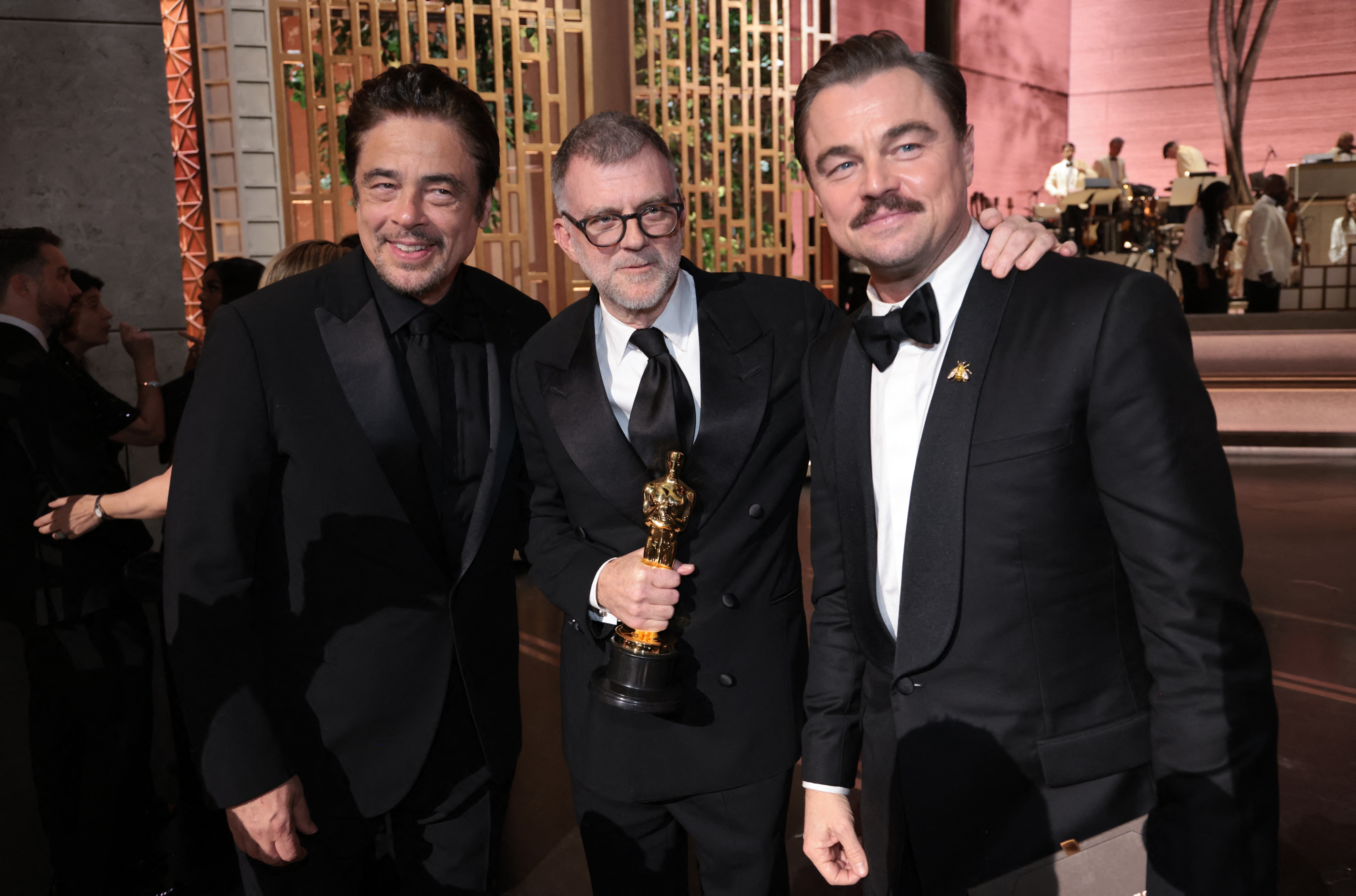 Actor Benicio Del Toro, filmmaker Paul Thomas Anderson and actor Leonardo DiCaprio holding the Oscar for Best Picture for One Battle After Another during the 98th Annual Academy Awards