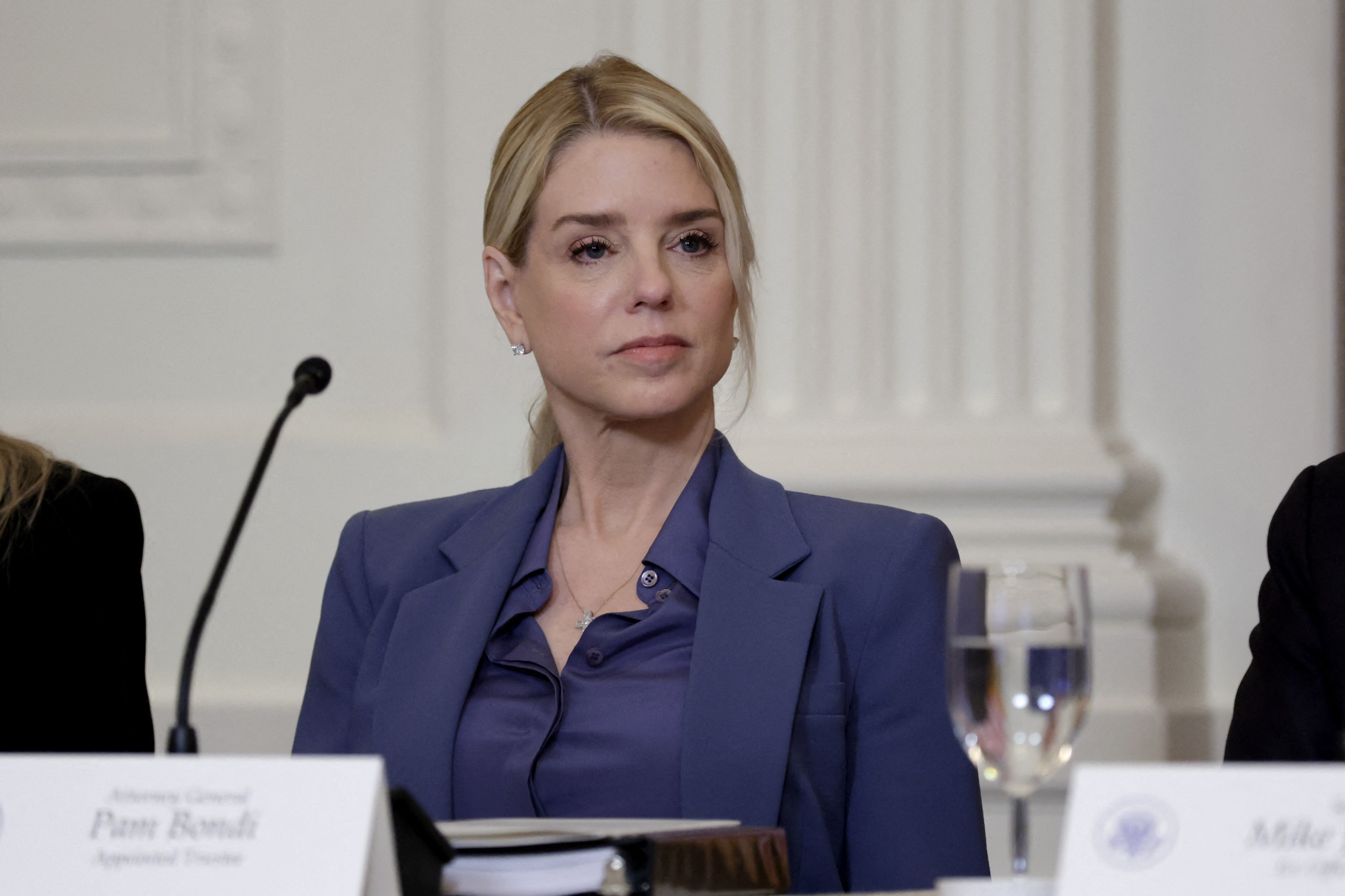 WASHINGTON, DC - MARCH 16: U.S. Attorney General Pam Bondi listens as U.S. President Donald Trump speaks during a lunch with the Trump Kennedy Center Board Members in the East Room of the White House on March 16, 2026 in Washington, DC. President Trump convened the board of trustees of the Trump Kennedy Center to vote on a proposal to close the institution for two years of major renovations. Alex Wong/Getty Images/AFP (Photo by ALEX WONG / GETTY IMAGES NORTH AMERICA / Getty Images via AFP)