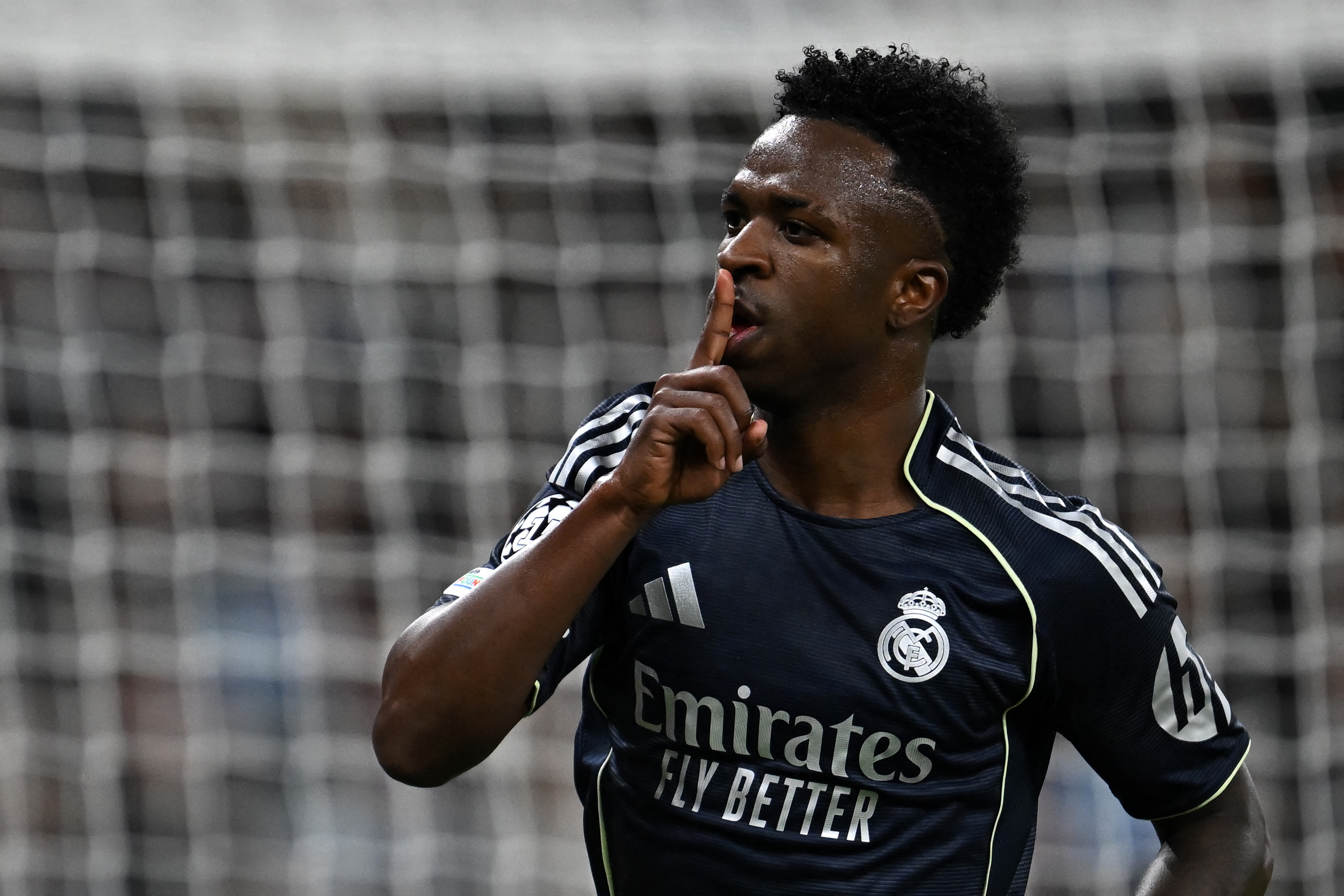 Real Madrid's Brazilian forward #07 Vinicius Junior celebrates scoring the opening goal during the UEFA Champions League, round of 16 second leg football match between Manchester City and Real Madrid at the Etihad Stadium in Manchester, north west England, on March 17, 2026. (Photo by Paul ELLIS / AFP)
