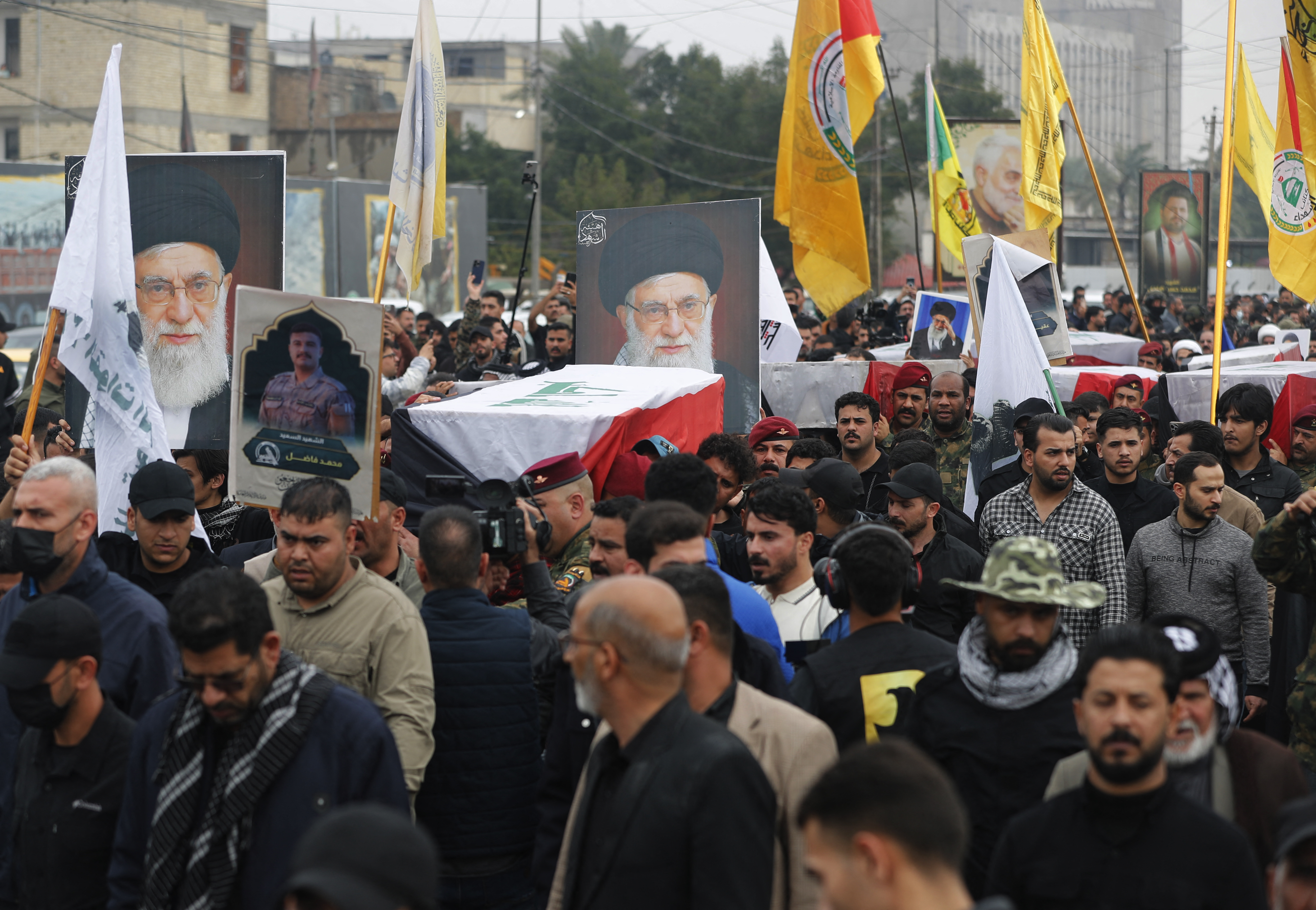 Members of Iraq's Hashed al-Shaabi, an alliance of factions now integrated into the regular army, carry the coffin of the Hashd al-Shaabi operations commander for Al-Anbar, Saad Dawai alongside others during a mass funaral in Baghdad on March 24, 2026.