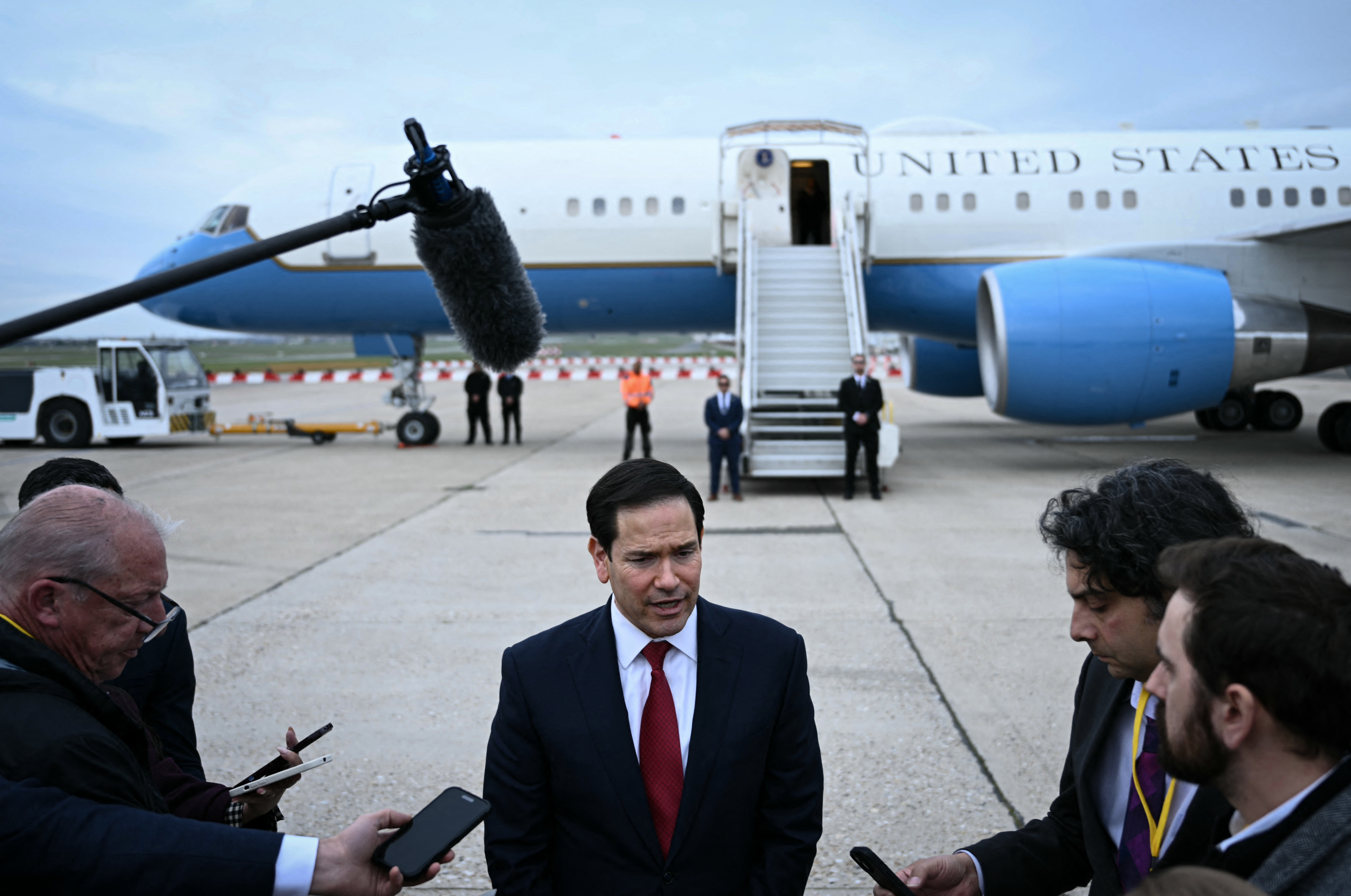 TOPSHOT - US Secretary of State Marco Rubio (C) speaks to the press following a G7 Foreign Ministers' meeting with Partner Countries before his departure at the Bourget airport in Le Bourget, outside Paris, on March 27, 2026.
