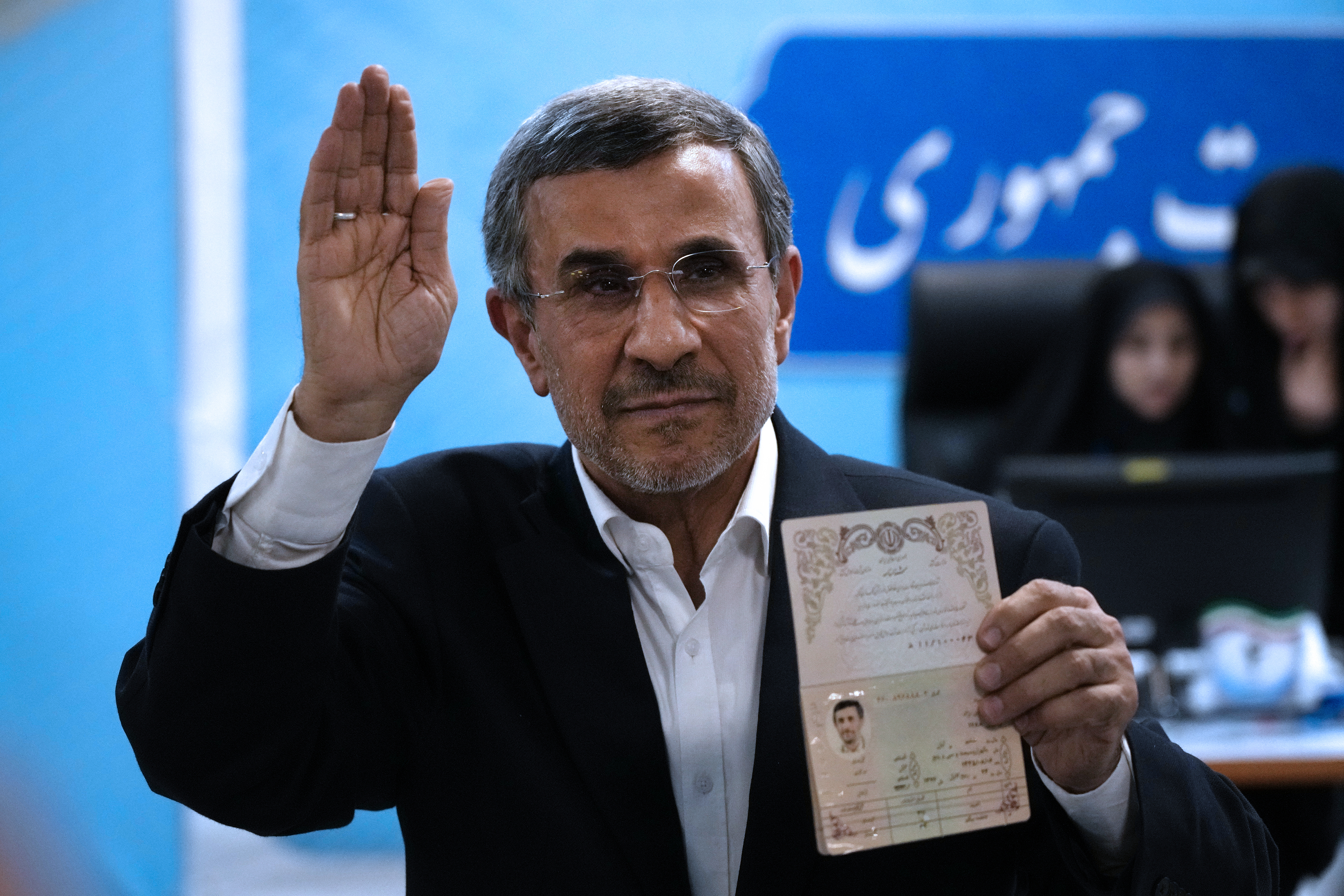 Iran's former President Mahmoud Ahmadinejad shows his identification document.