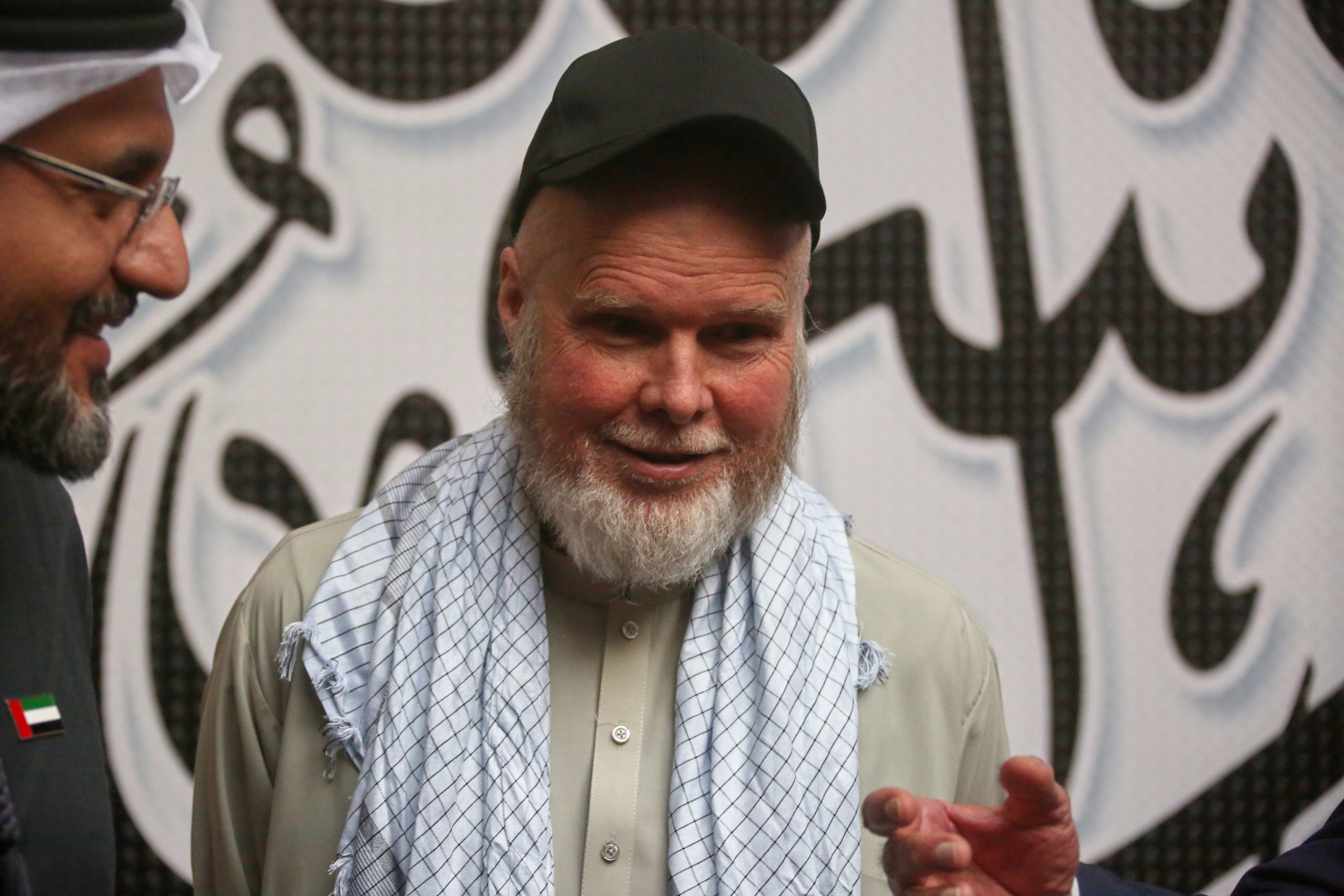 American Dennis Coyle smiles after being released by Afghanistan's Taliban authorities, who had held him for over a year, before boarding a plane at the airport in Kabul, Afghanistan, Tuesday, March 24, 2026. (AP Photo/Mudassir Safi)