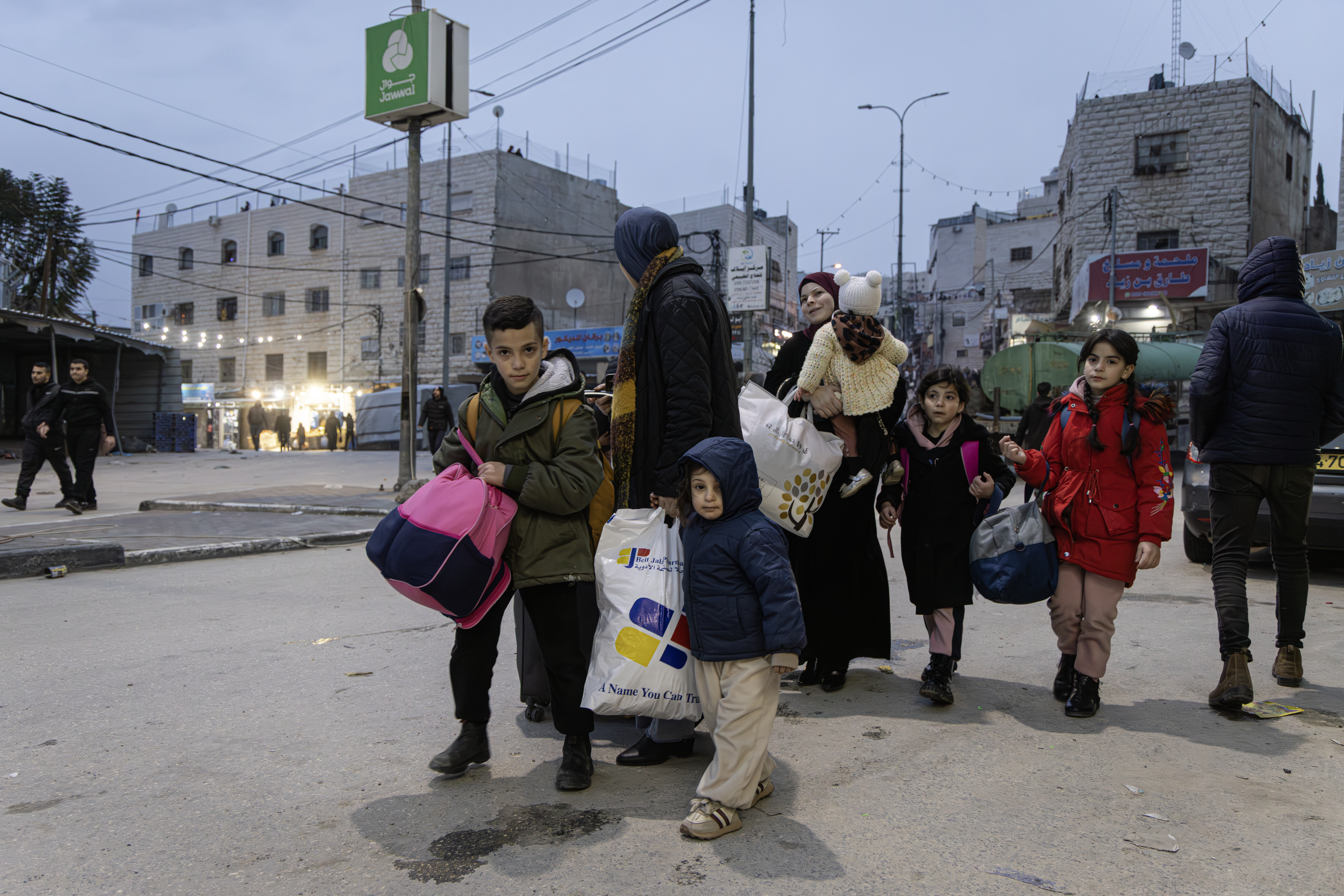 HEBRON, WEST BANK - JANUARY 21: Several families leave for Hebron and other Palestinian towns, fearing the continuation of the military operation and taking advantage of the temporary lifting of the curfew on January 21, 2026 in Hebron. Israeli military initiated a "large-scale" multi-day operation in southern Hebron, targeting the Jabal Johar area to dismantle alleged "terror infrastructure" and seize illegal weapons. The raid involved hundreds of soldiers and heavy machinery leading to a total curfew for approximately 70,000 residents. As the operation continues into its third day, military forces maintain a lockdown with new gates and barriers while conducting searches and making multiple arrests. (Photo by Faiz Abu Rmeleh/Getty Images)