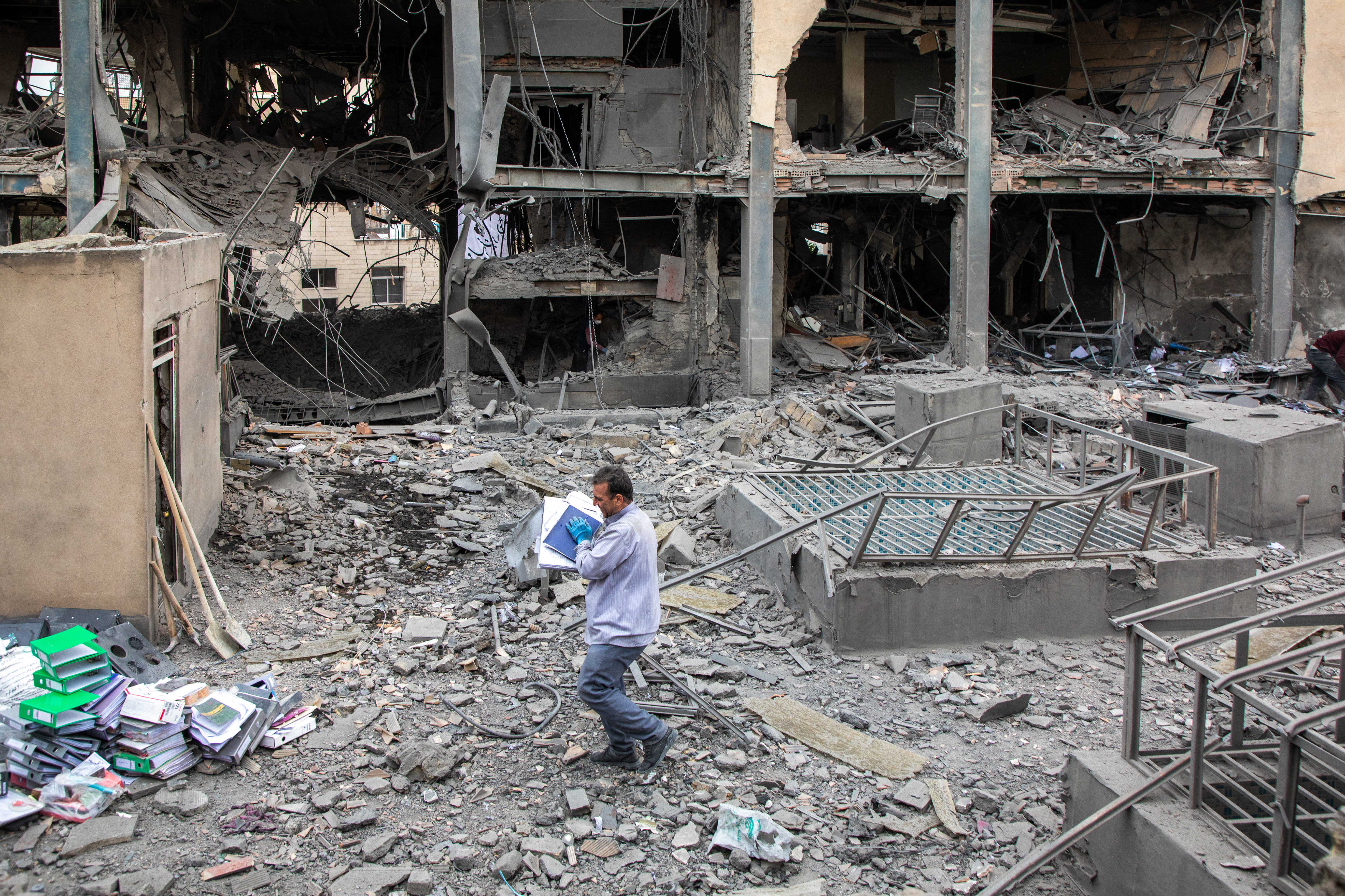 People work to recover items from the site of a US-Israeli attack on a commercial district on March 29, 2026 in Tehran, Iran