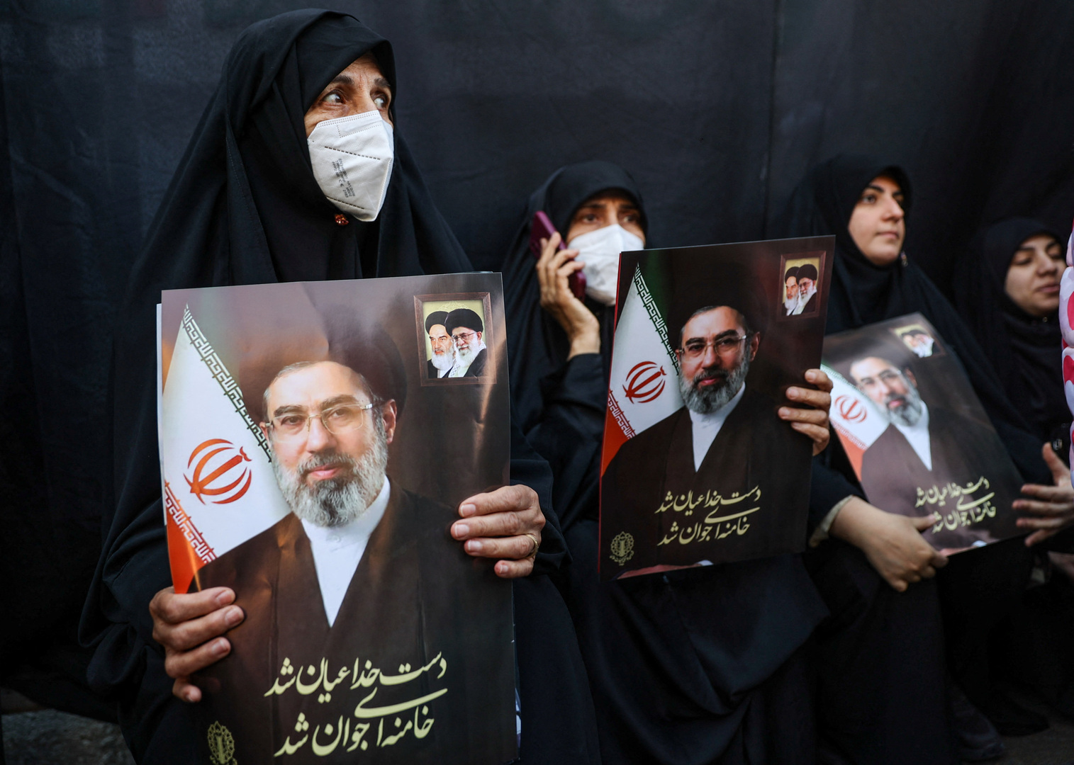 Iranian women holding up photos of the country's new supreme leader, Mojtaba Khamenei, in Tehran, Iran, Monday, March 9, 2026[Vahid Salemi/ AP Photo]