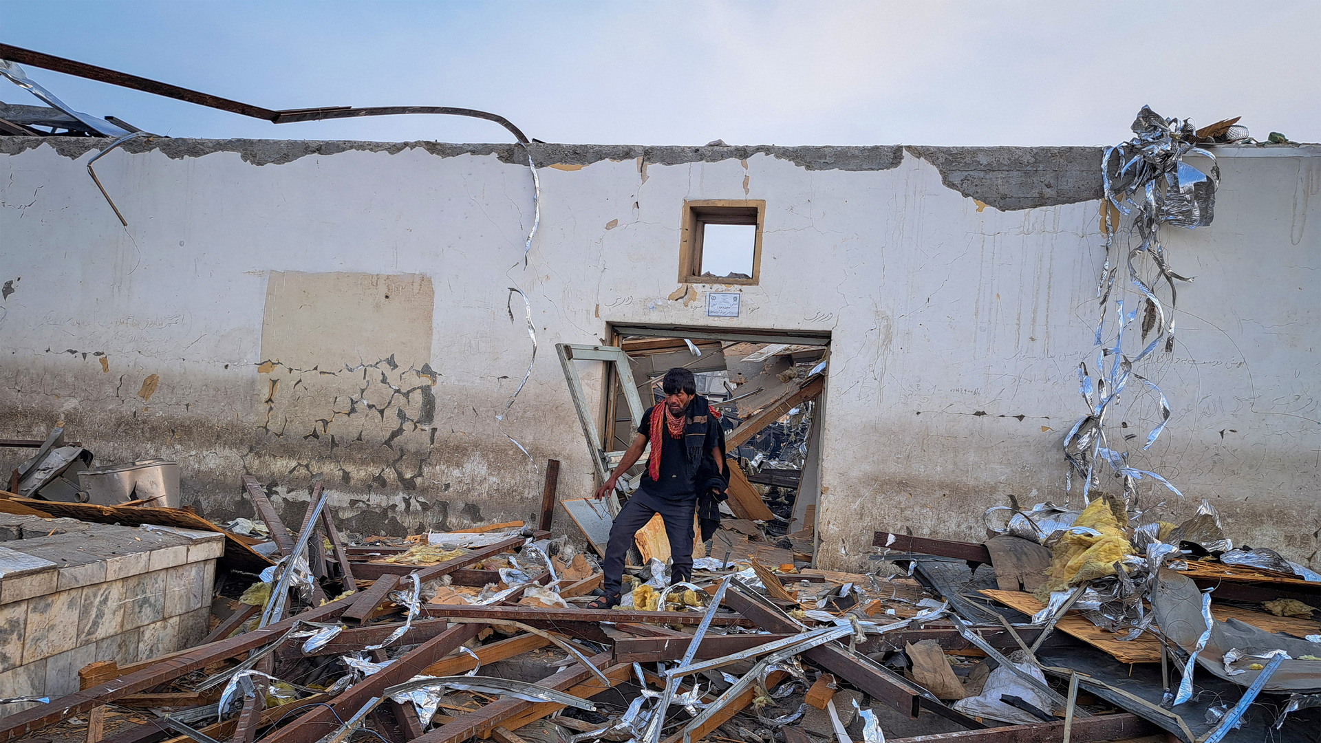 Family members have gathered by the rubble of a hospital in Kabul searching for their loved ones after an air attack.