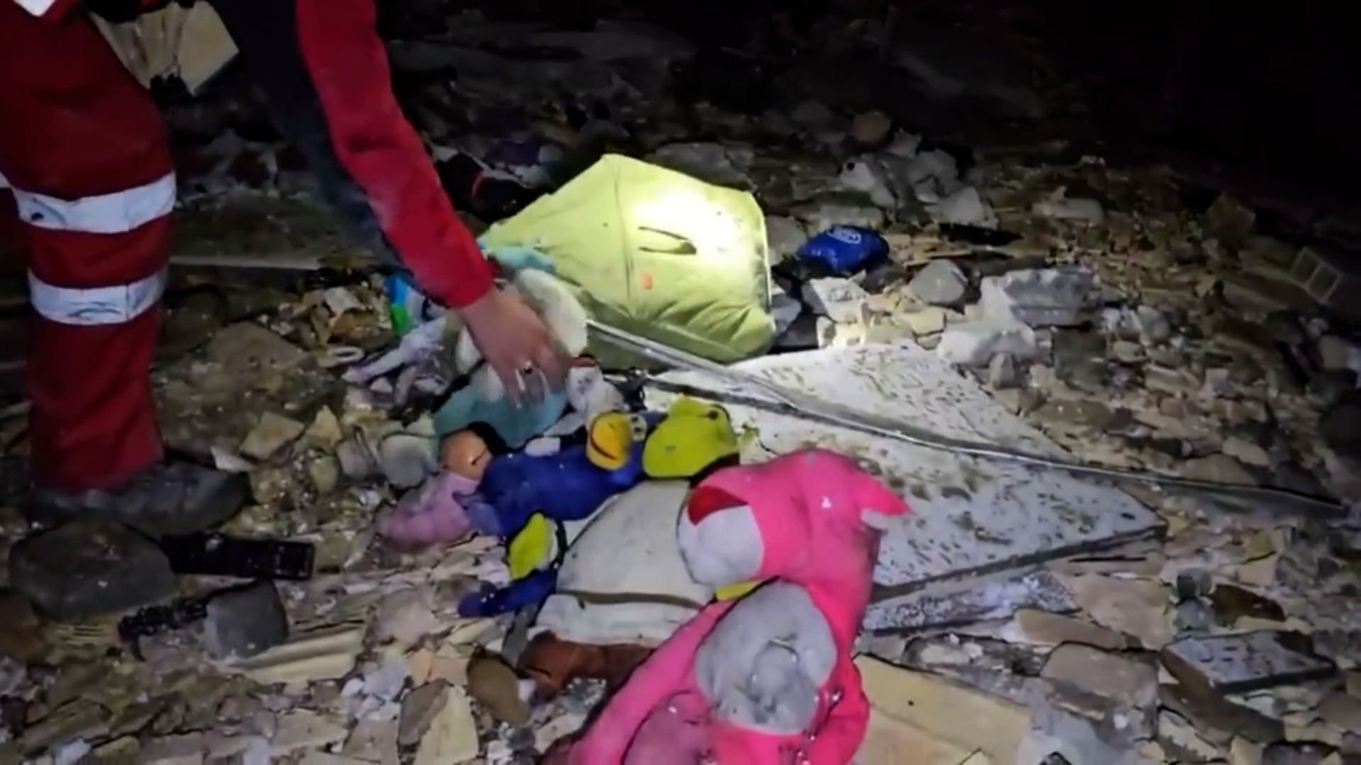 Rescue teams find children's toys in rubble of US-Israeli attack on Iran.